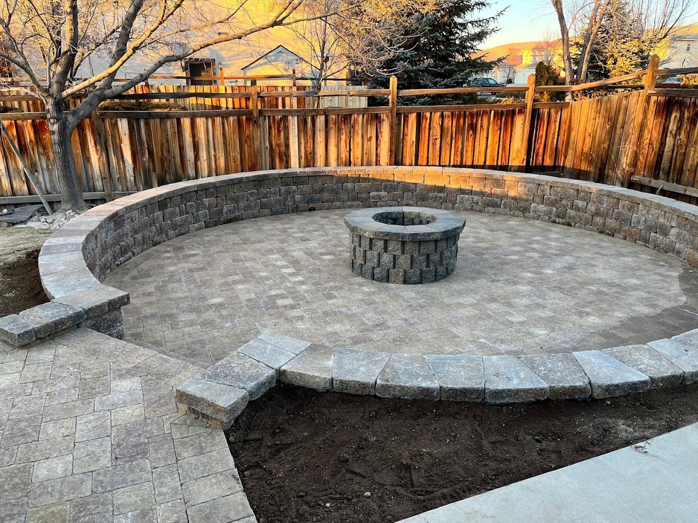 There is a fire pit in the middle of the patio.