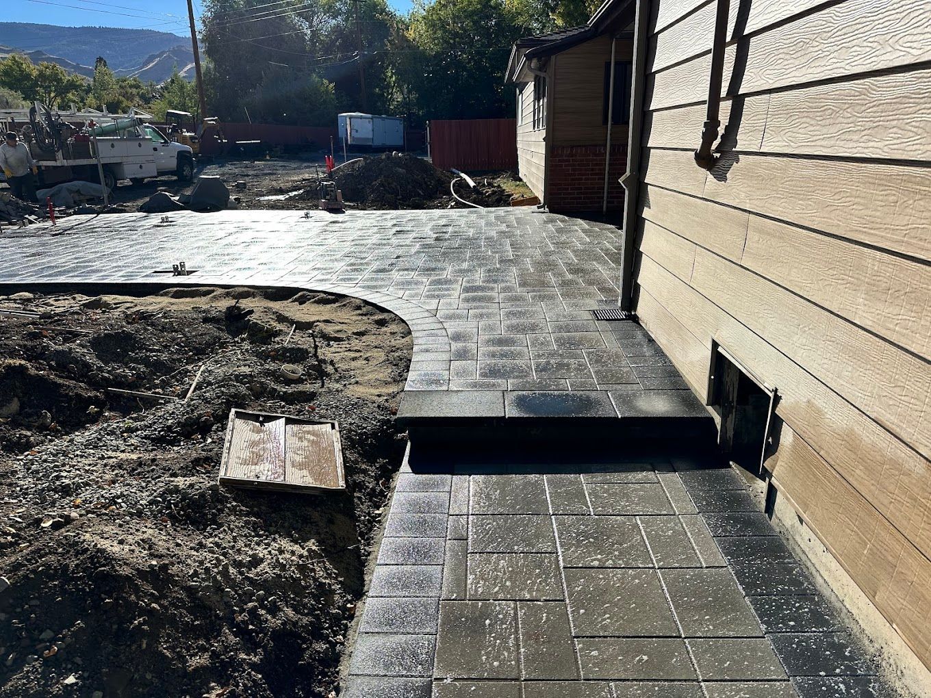 A sidewalk is being built in front of a house.