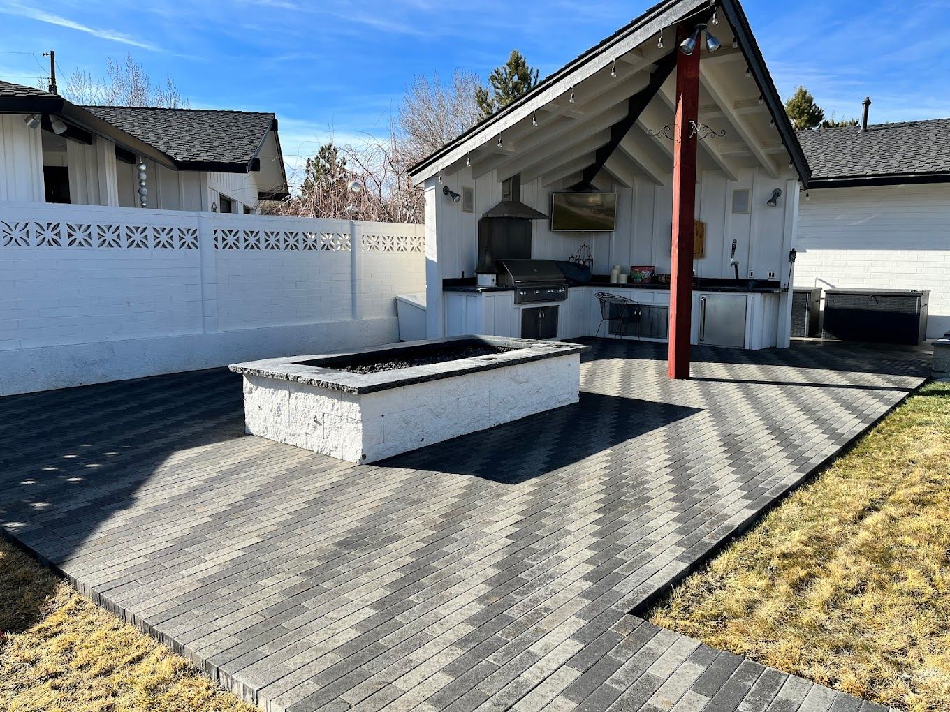 There is a fire pit in the backyard of a house.