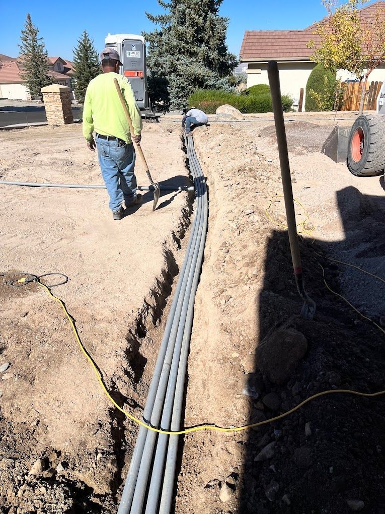 A man is digging in the dirt with a shovel