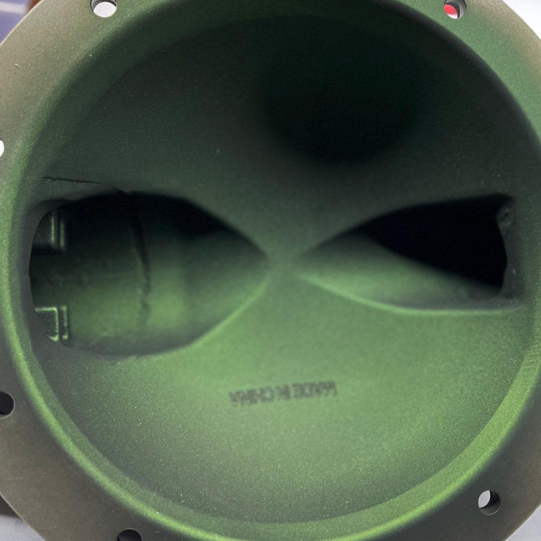 Green speaker enclosure with two horn-shaped openings and