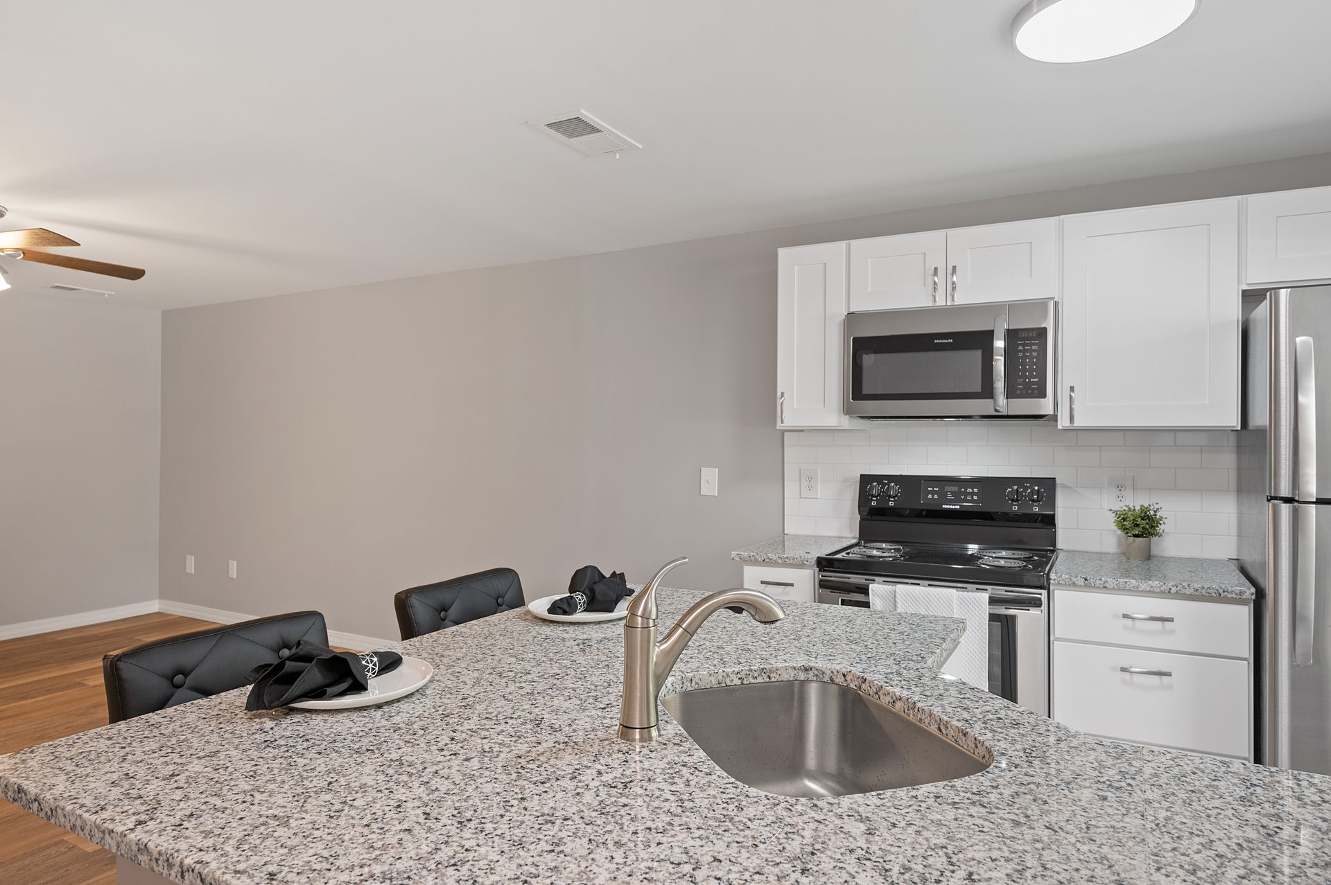 Image of expansive island and white kitchen cabinets