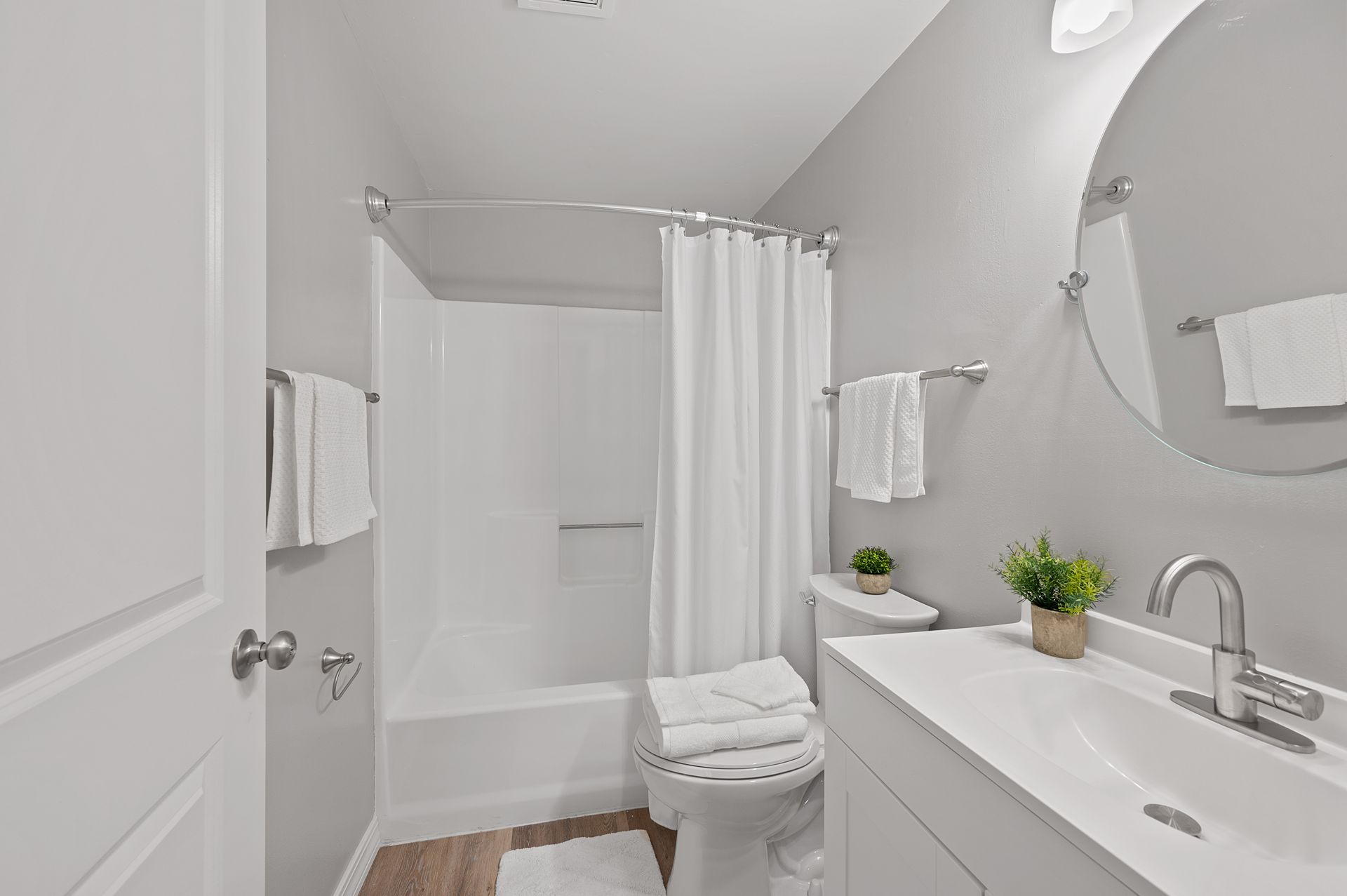 updated bathrooms with curved shower rod