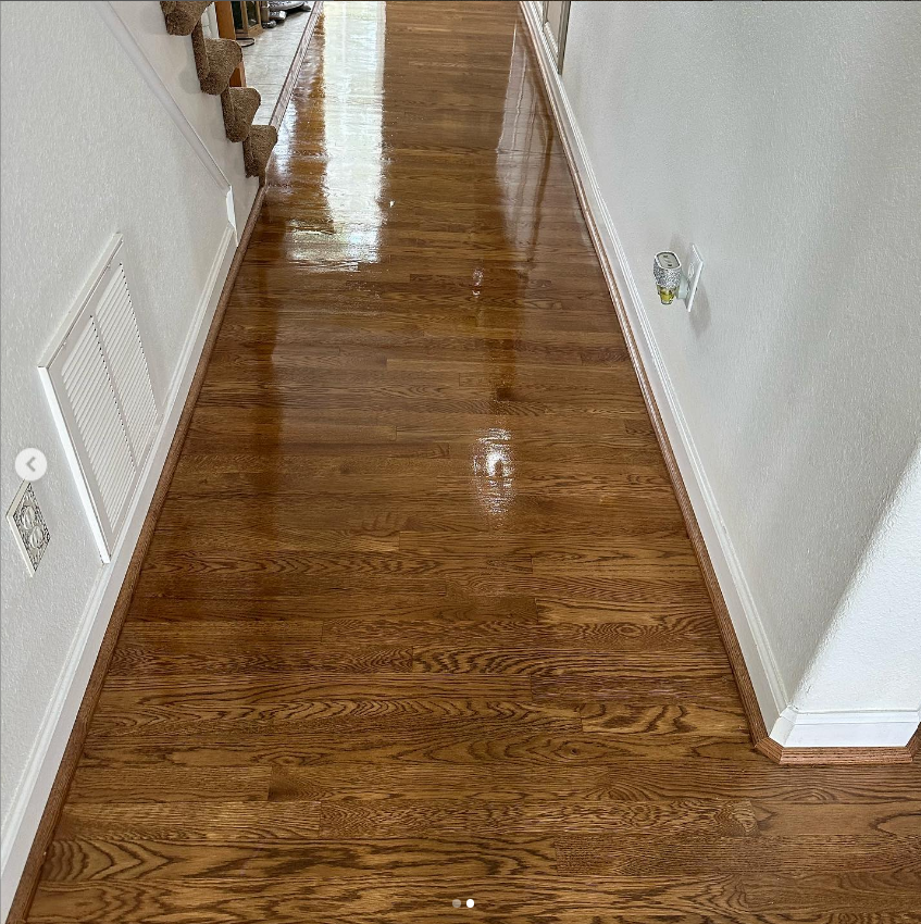 a hallway with hardwood floors and stairs in a house .