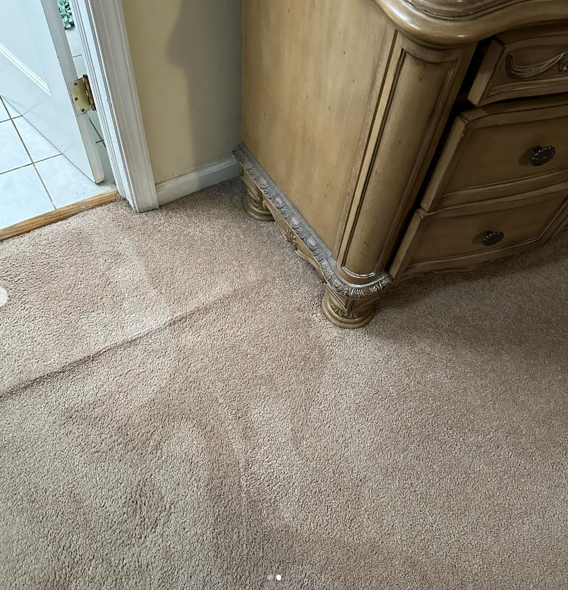 a wooden dresser is sitting on a carpeted floor next to a door .