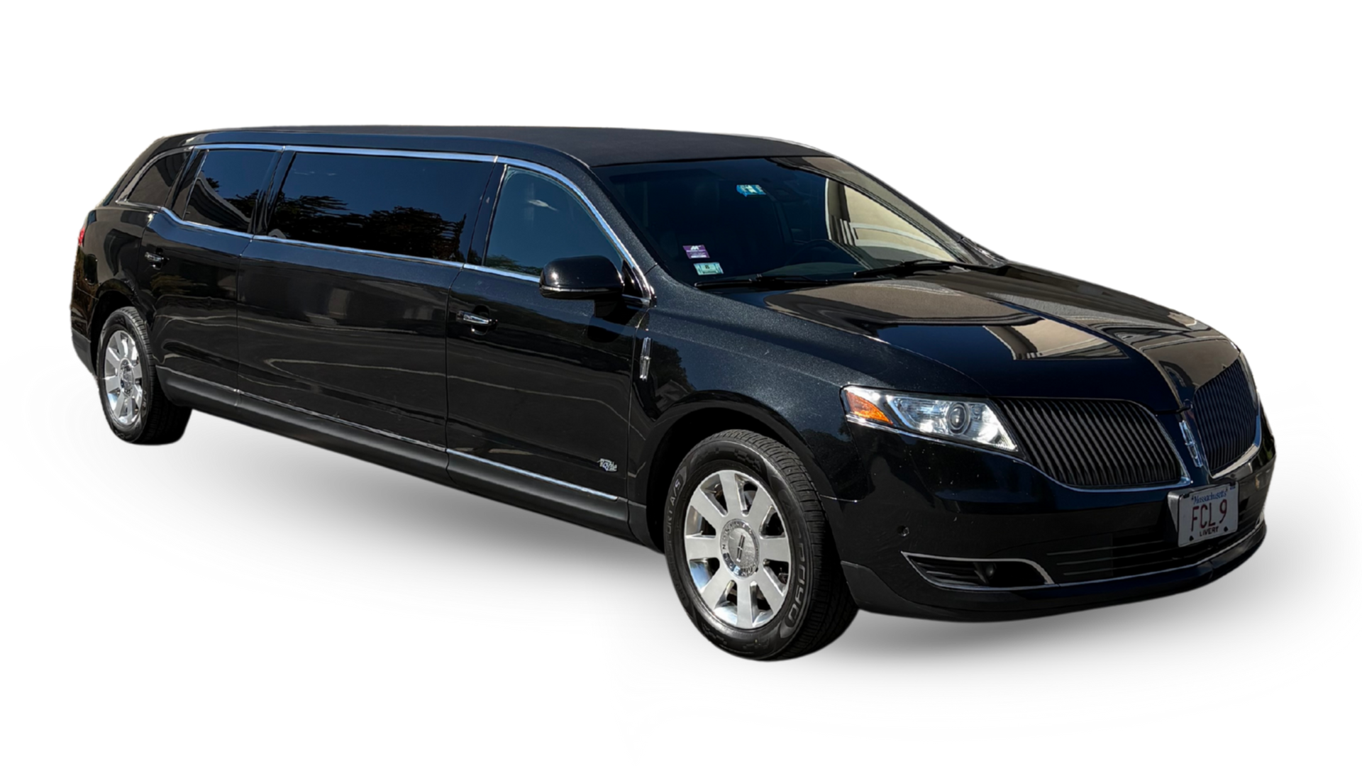 A long, silver Hummer limousine parked outdoors.