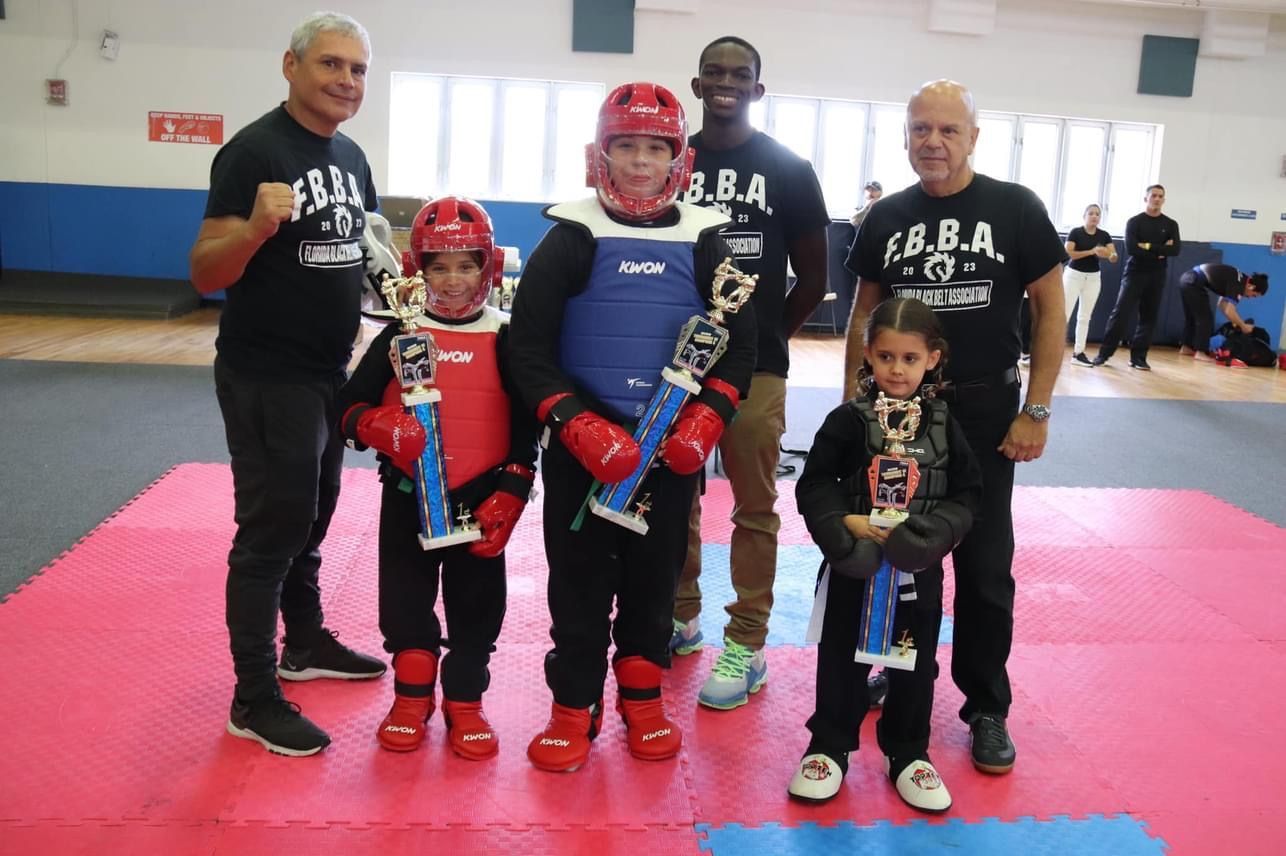 A group of people are posing for a picture in a gym.