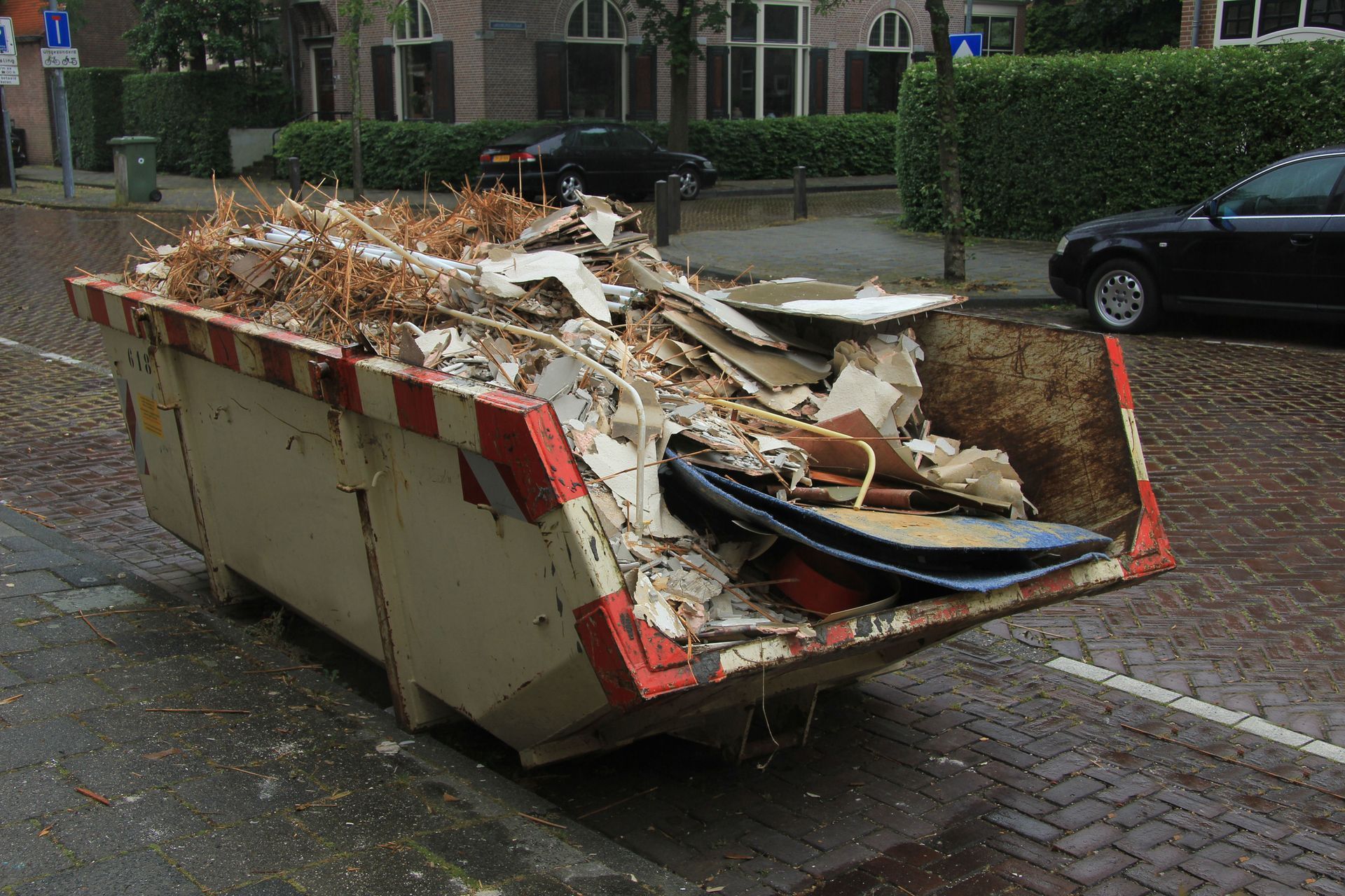 A dumpster situated by the road, representing local junk removal services in Worcester, MA.