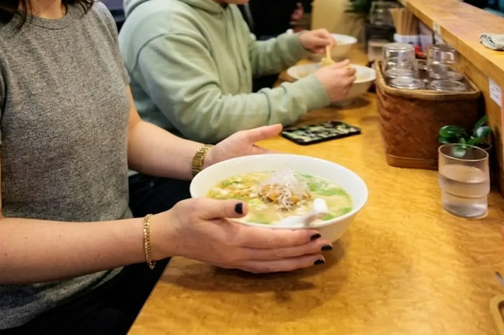 Steaming bowl of traditional shoyu ramen with chashu, ajitama egg, and green onions.