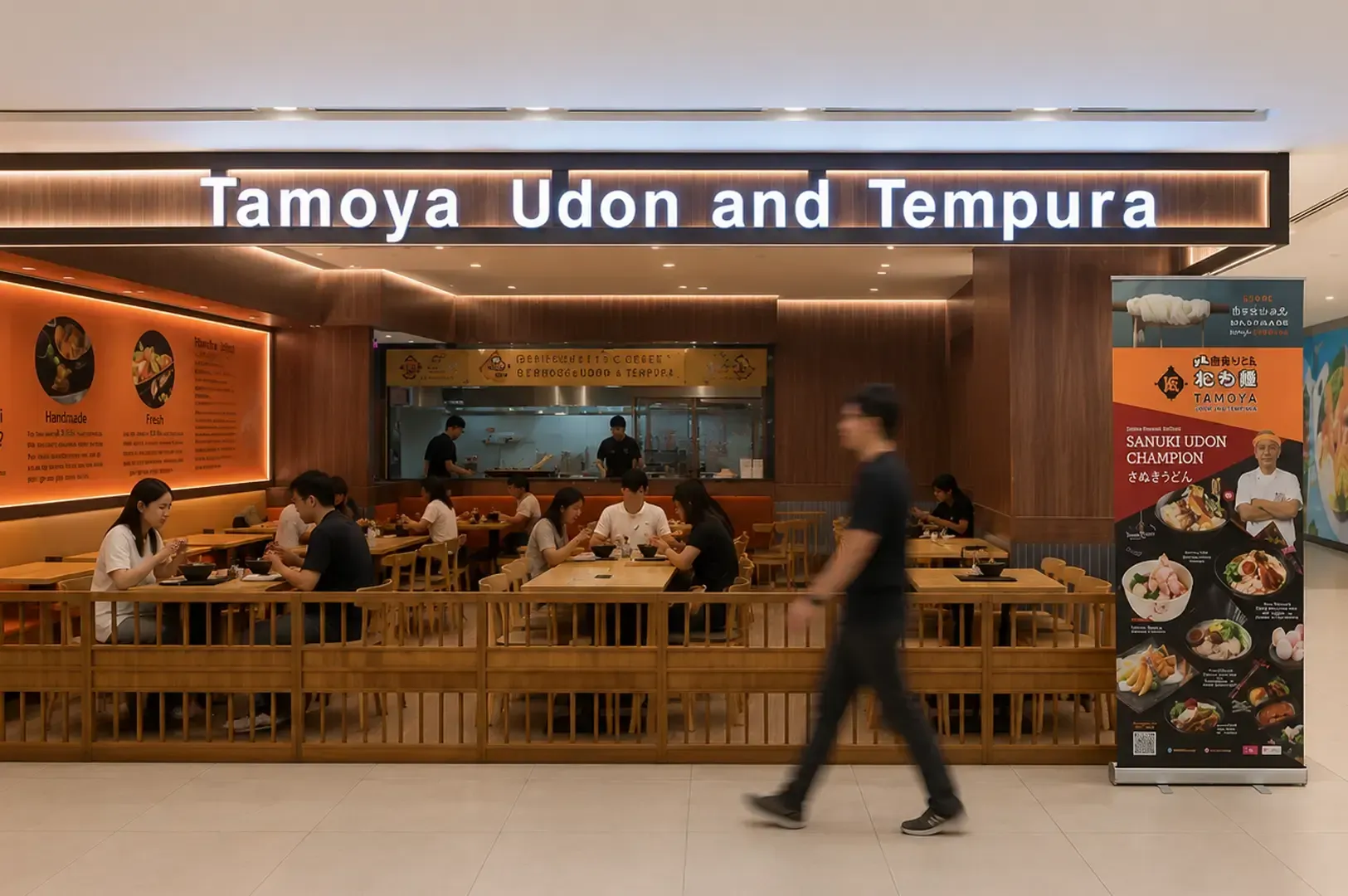 Storefront of Tamoya Udon and Tempura restaurant in a shopping mall with customers dining inside