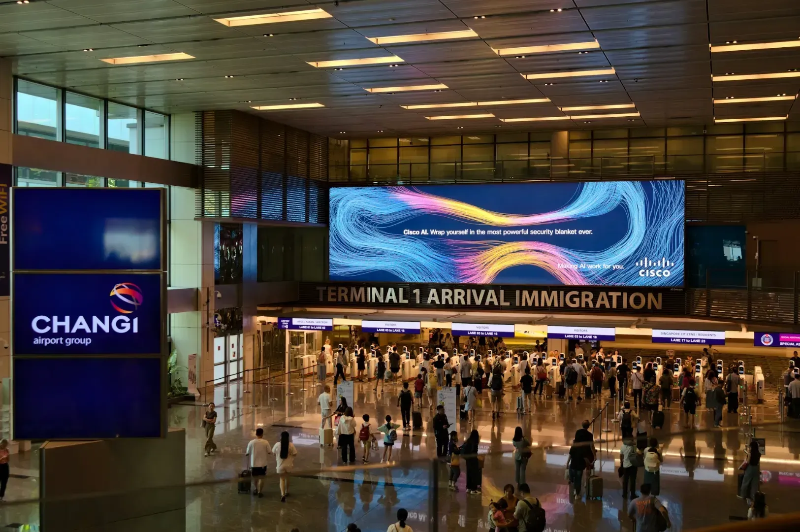 Changi Airport's Terminal 1 immigration area with a bright digital ad above. People queue in lines, creating a busy and organized atmosphere.