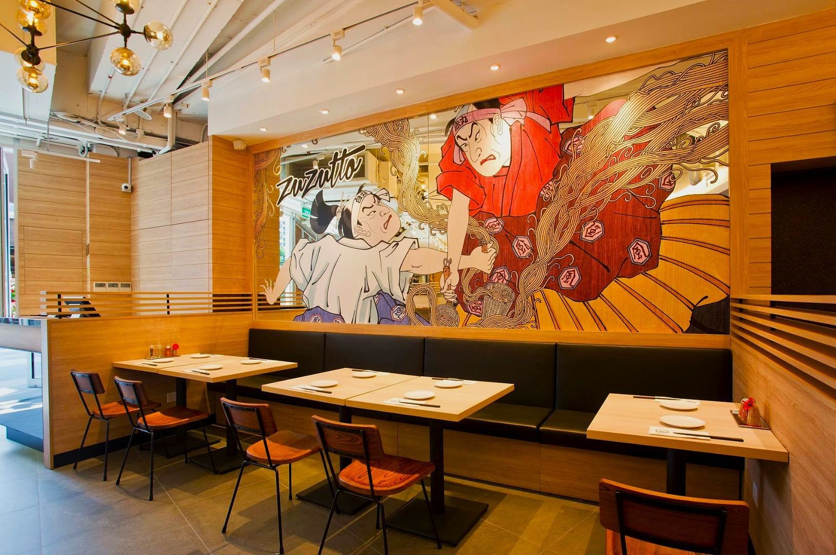 Storefront of Nanami Yakiniku, a Japanese BBQ restaurant, with a large white sign, glass entry doors, and a warmly lit interior visible through the windows.