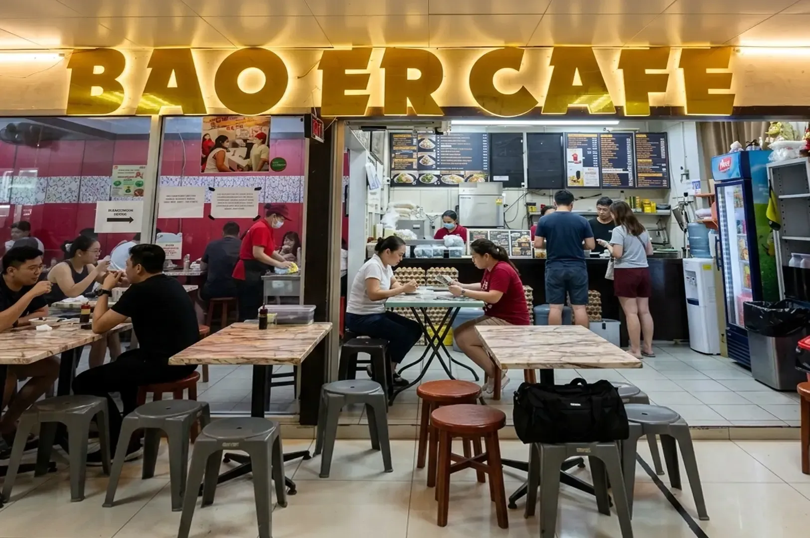 Bao Er Cafe bustling interior with diners at tables and staff serving customers