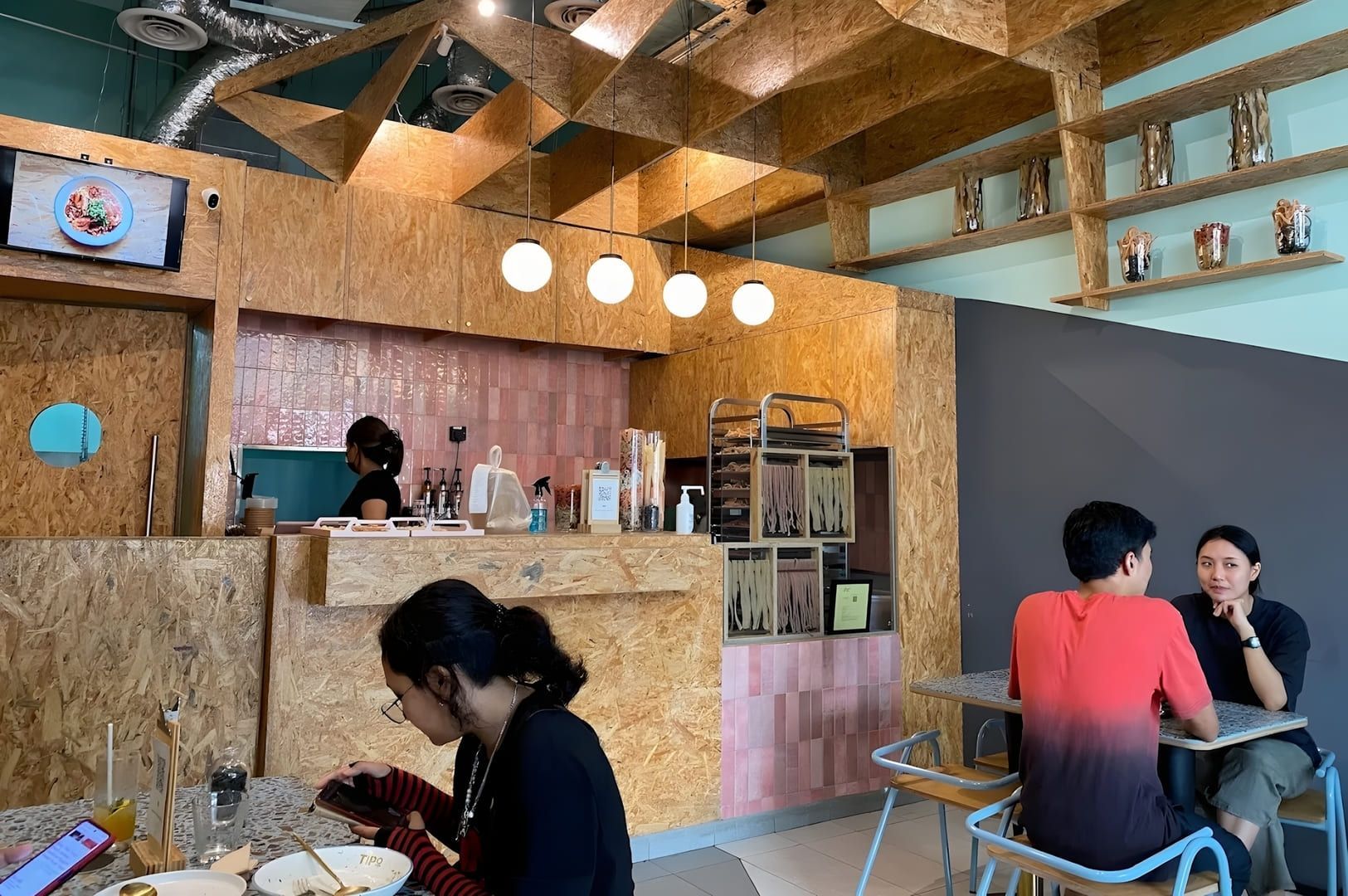 Patrons gathered at tables in Tipo Strada restaurant, Novena, Singapore.