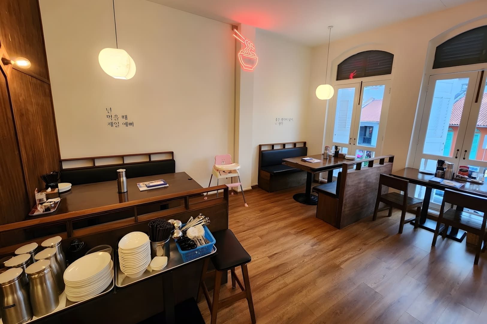 Interior view of O.BBa Jjajang restaurant in Tanjong Pagar, Singapore, showcasing wooden floors and tables.