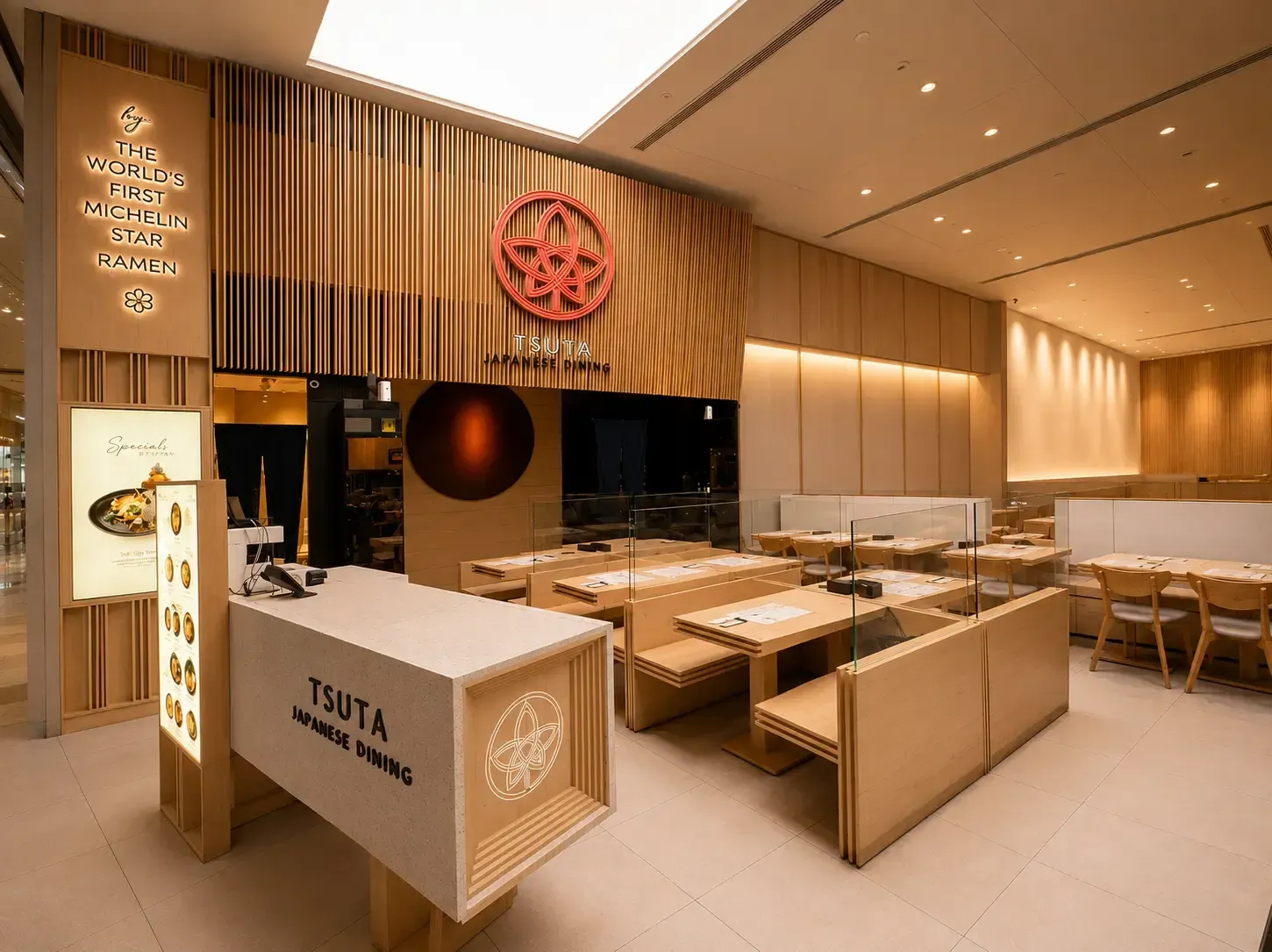 Cozy Japanese dining counter lined with photos of menu items, decorative fans, and hanging fishing.