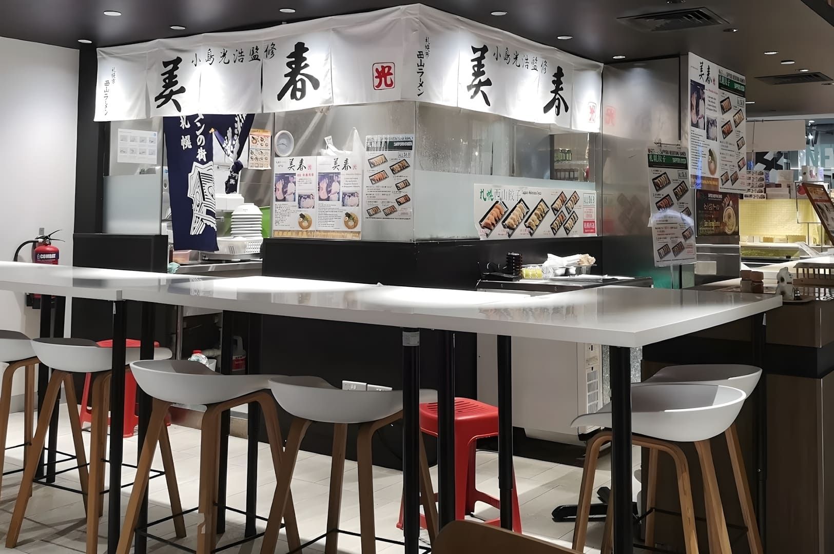 A view of Miharu Ramen restaurant featuring a counter with stools for customers to sit and enjoy.