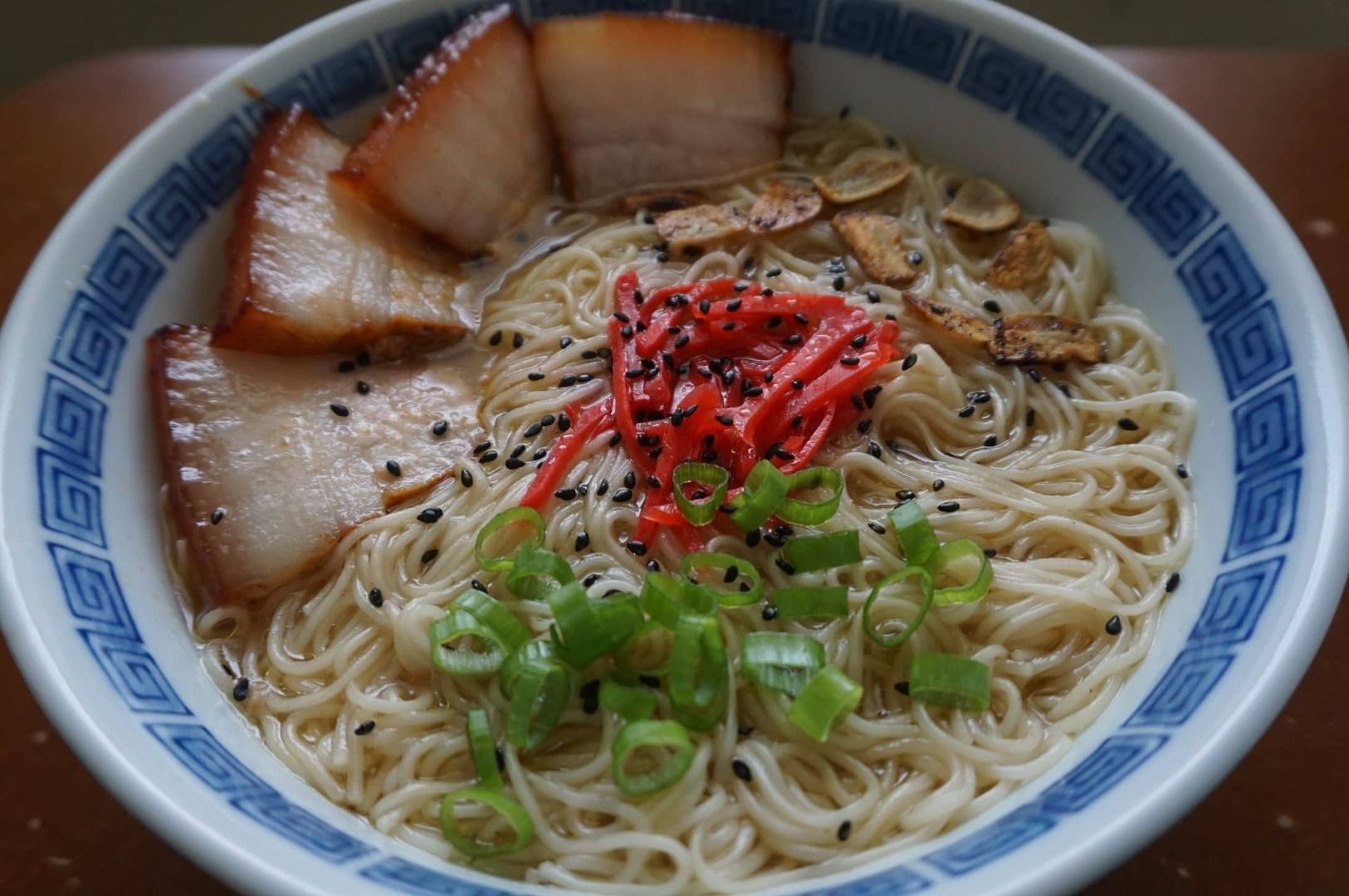 A serving of Hakata Ramen with tender noodles, meat, and fresh vegetables in a bowl.