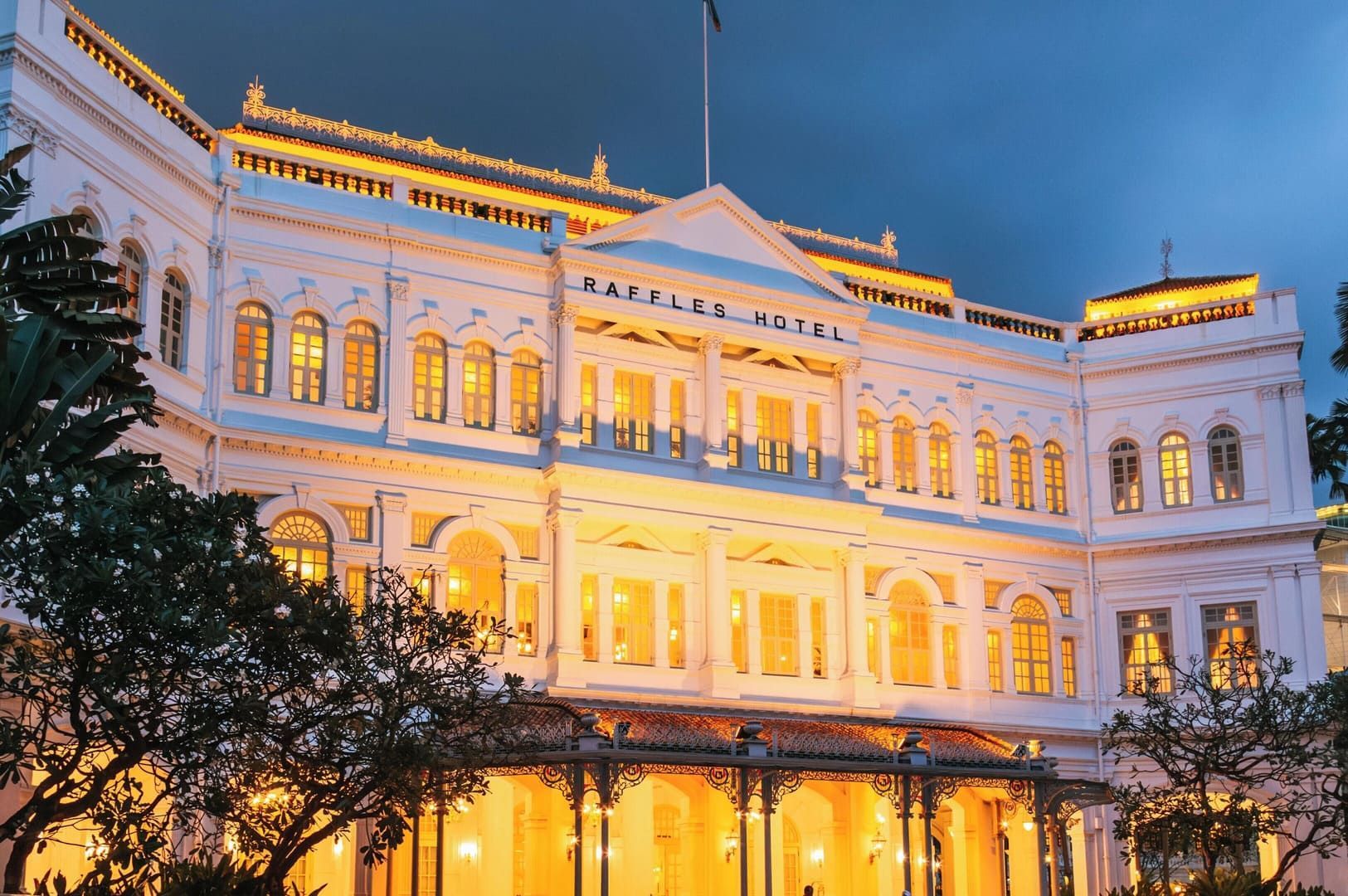 A hotel's exterior view in Singapore, showcasing its elegant architecture near Chijmes.