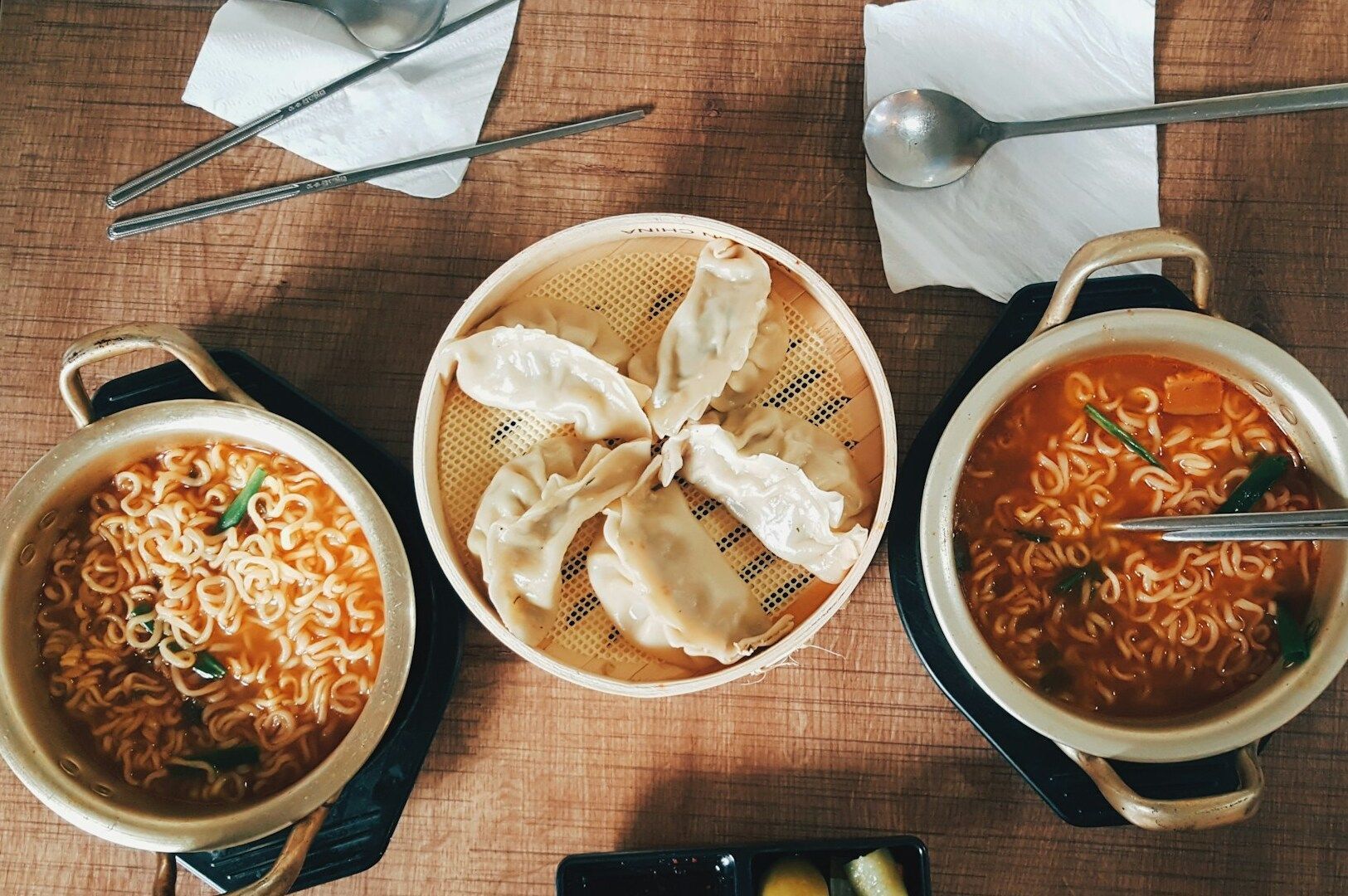 Two bowls of Korean ramen featuring noodles, with chopsticks placed beside each bowl for serving.