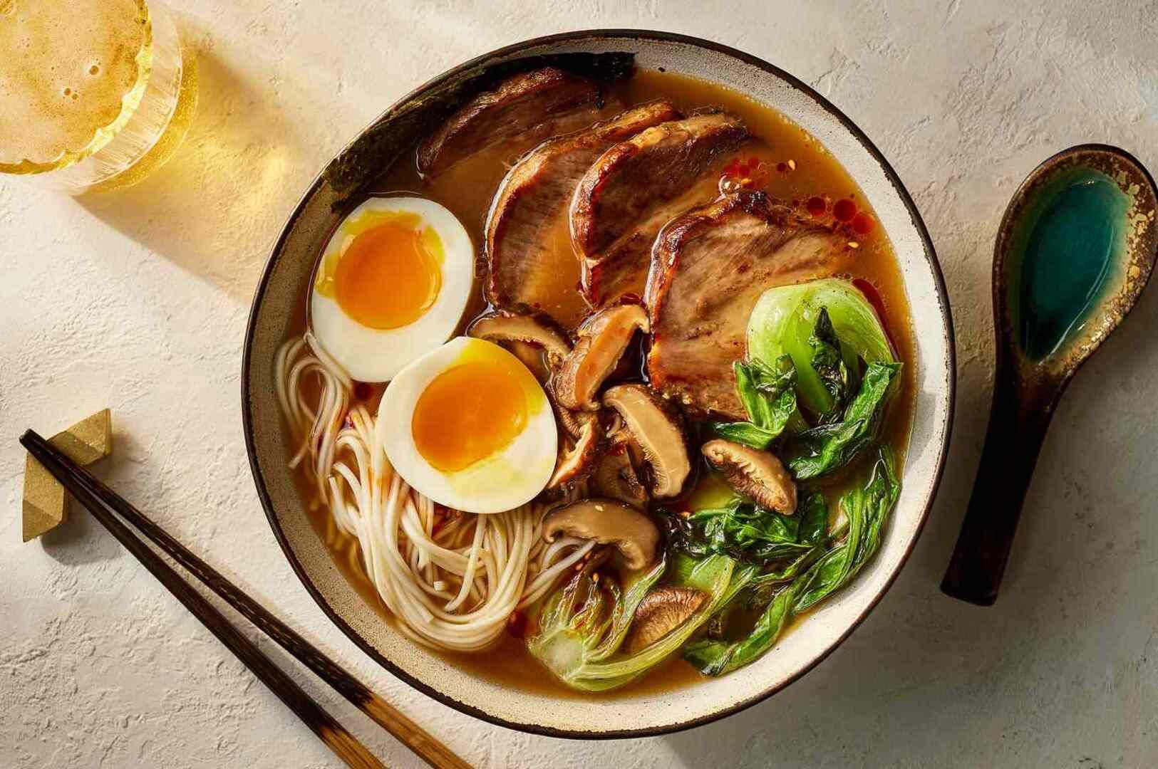 A bowl of Tonkotsu Black Ramen featuring meat, mushrooms, and a soft-boiled egg.