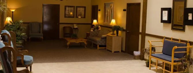 A hallway with a couch and chairs in it