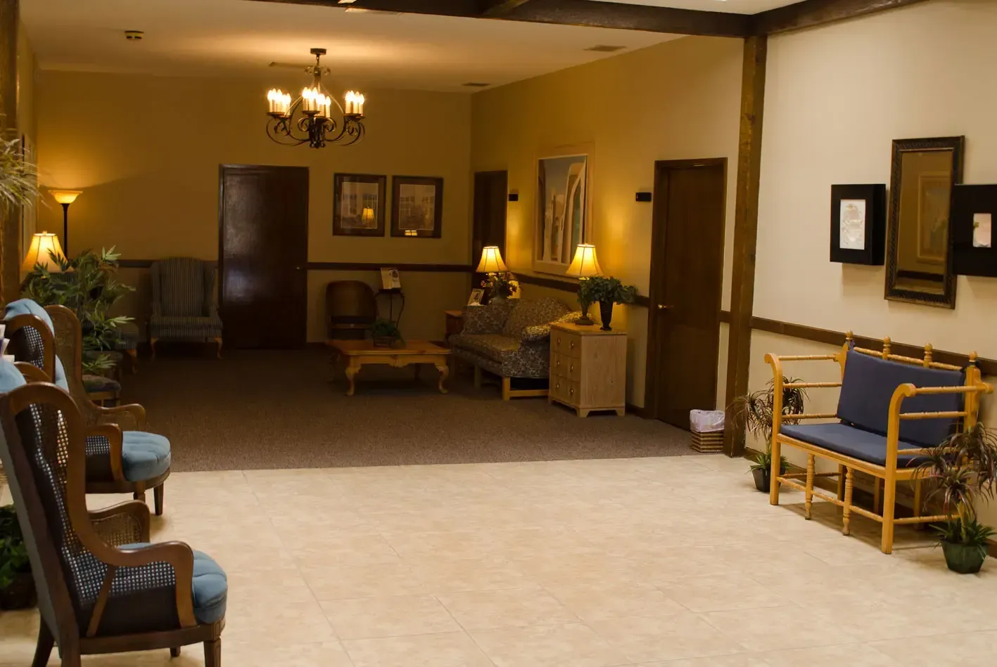 A living room with a couch and chairs and a chandelier