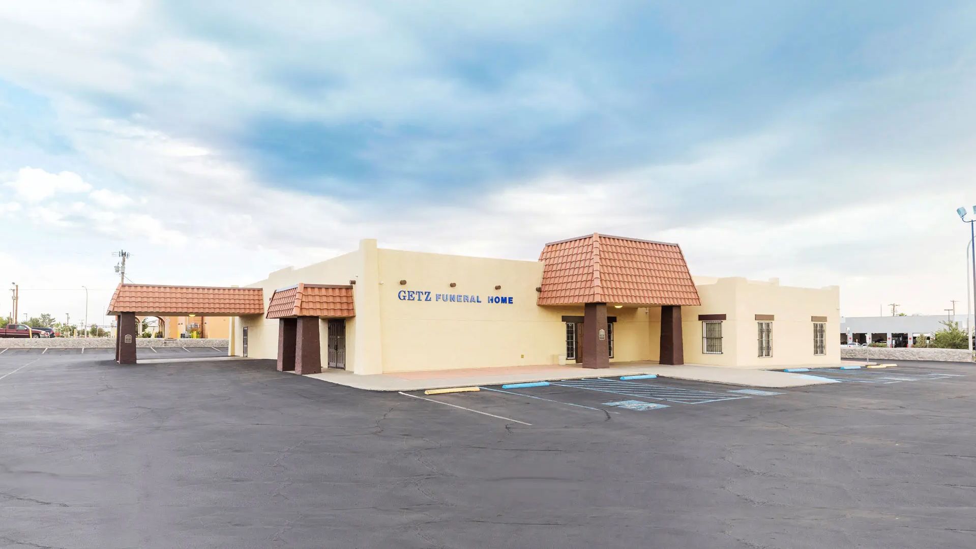 A large building with a parking lot in front of it.