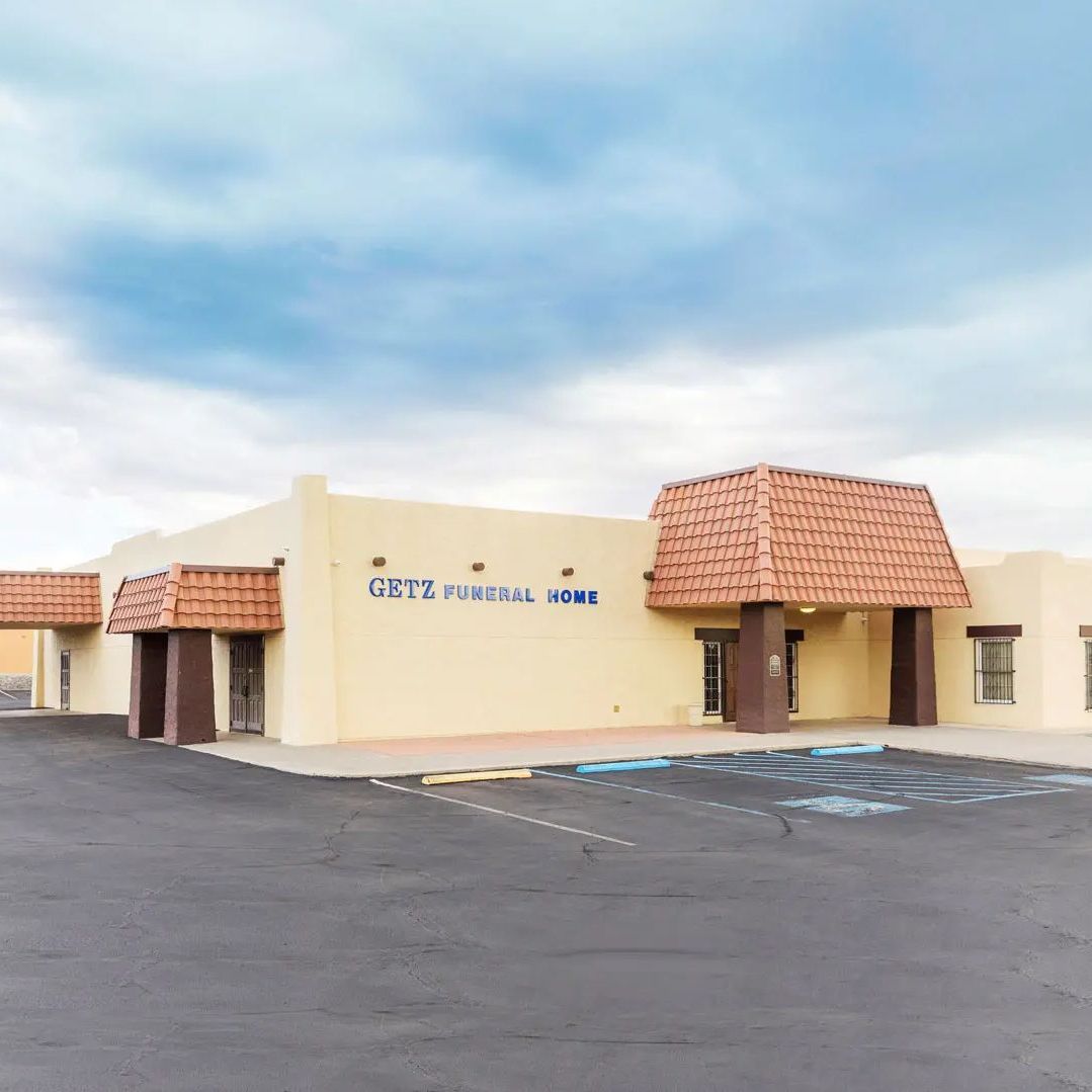 A large building with a parking lot in front of it