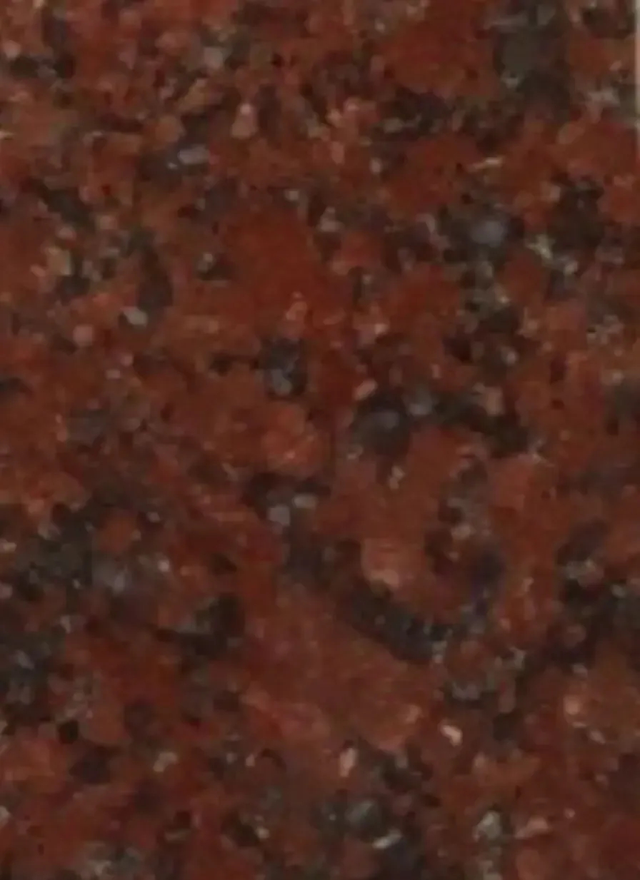 A close up of a red granite counter top