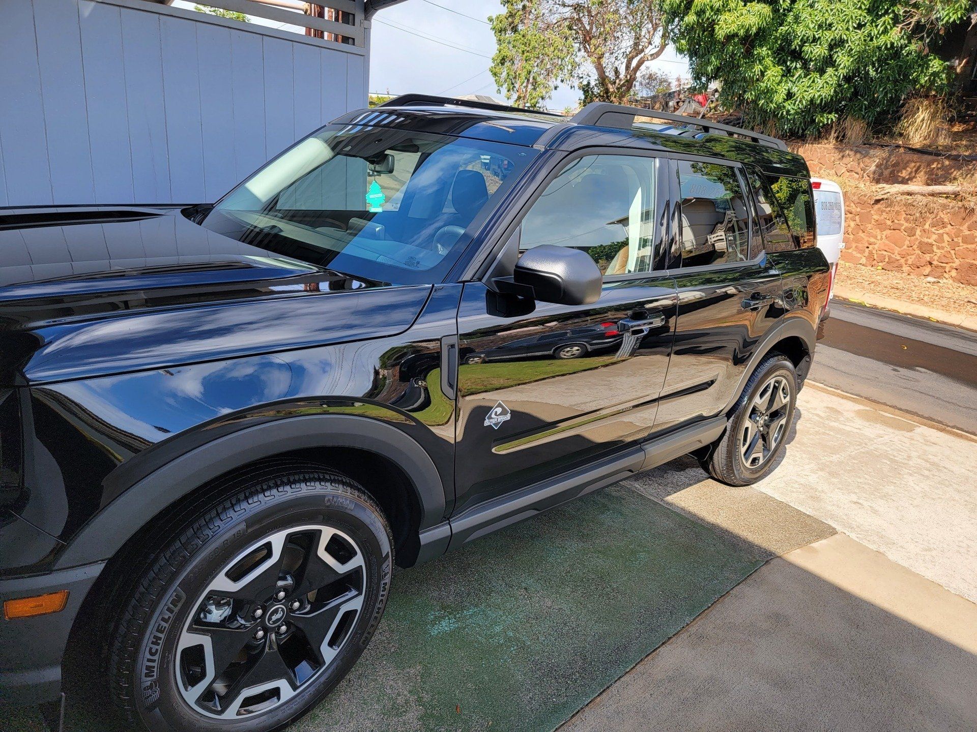 Black Ford Bronco SUV parked outdoors on a sunny day.