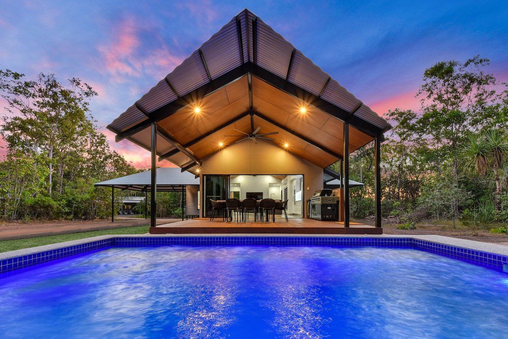 Modern tropical house with swimming pool in the foreground