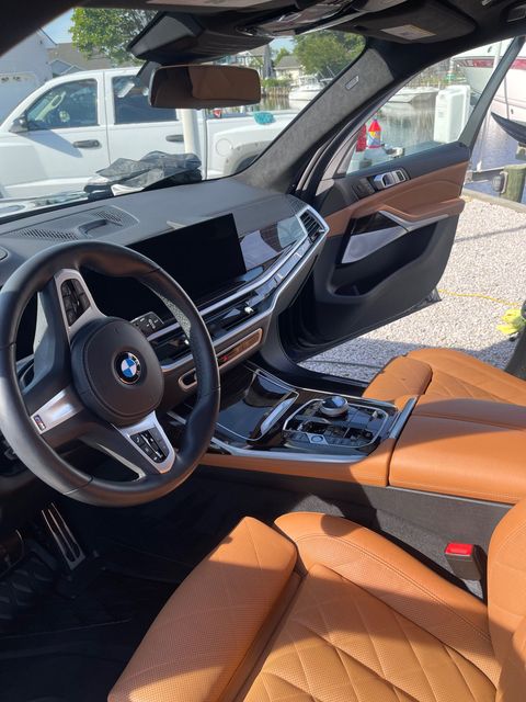 A BMW vehicle's interior showcasing premium leather seats and exquisite detailing, emphasizing comfort and sophistication.