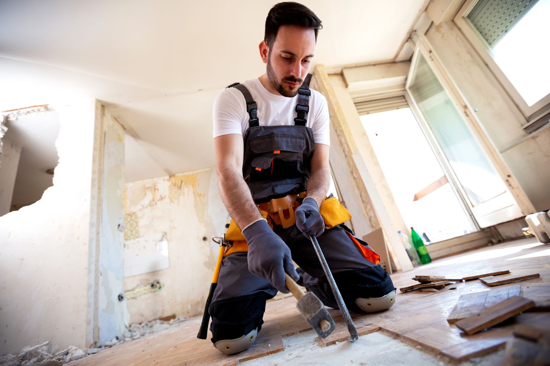 A man fixing tiles on the floor