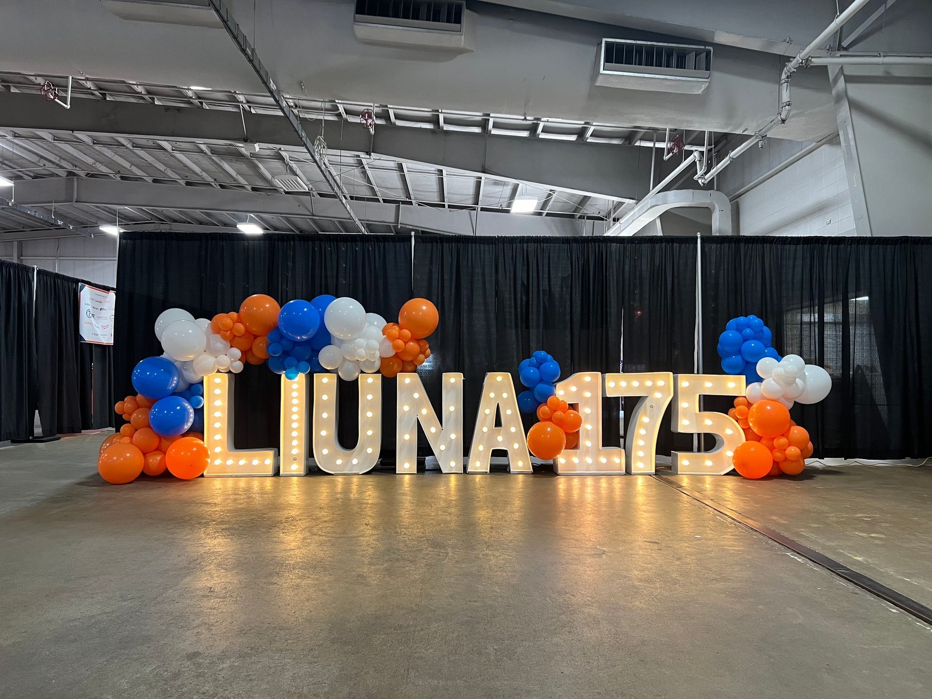 A sign that says liuna 175 is surrounded by balloons