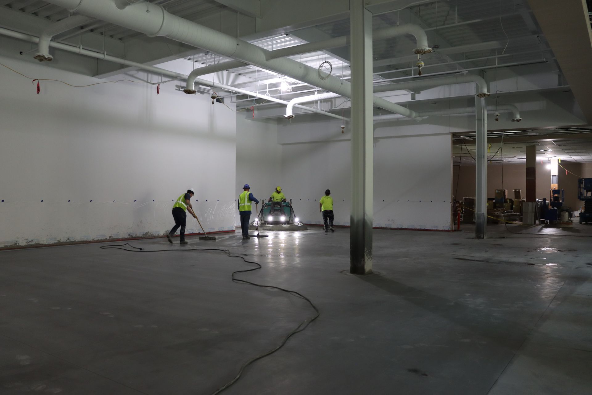A group of people are cleaning the floor of a building.