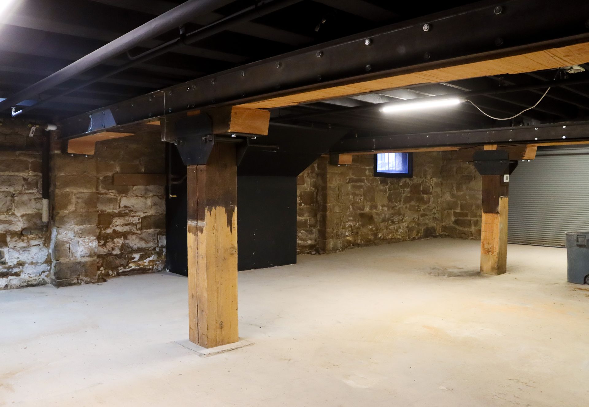 An empty basement with a tv on the wall