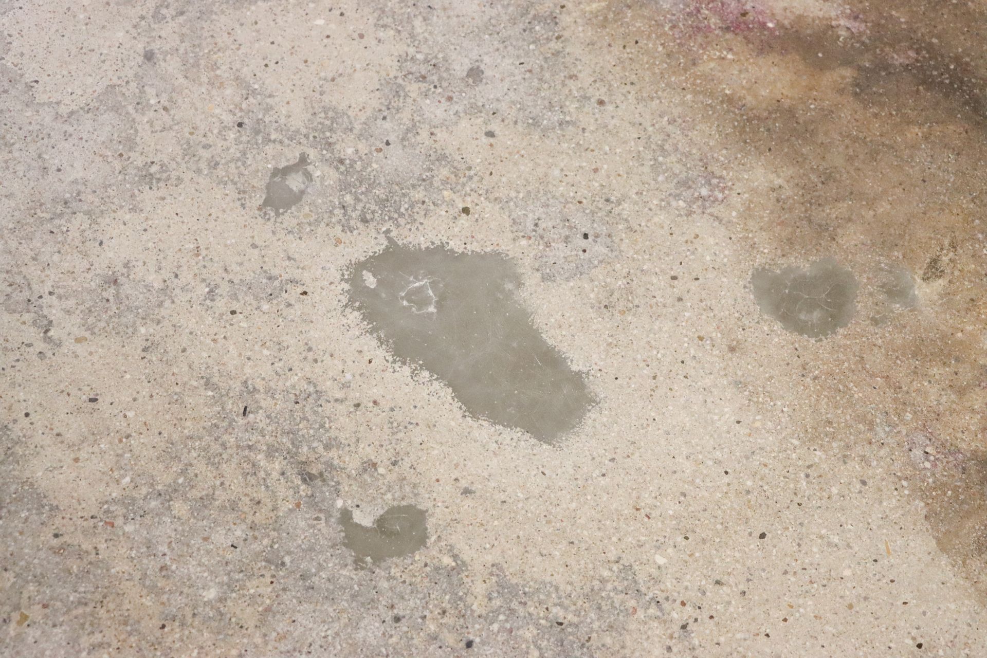 A close up of a concrete surface with a stain on it
