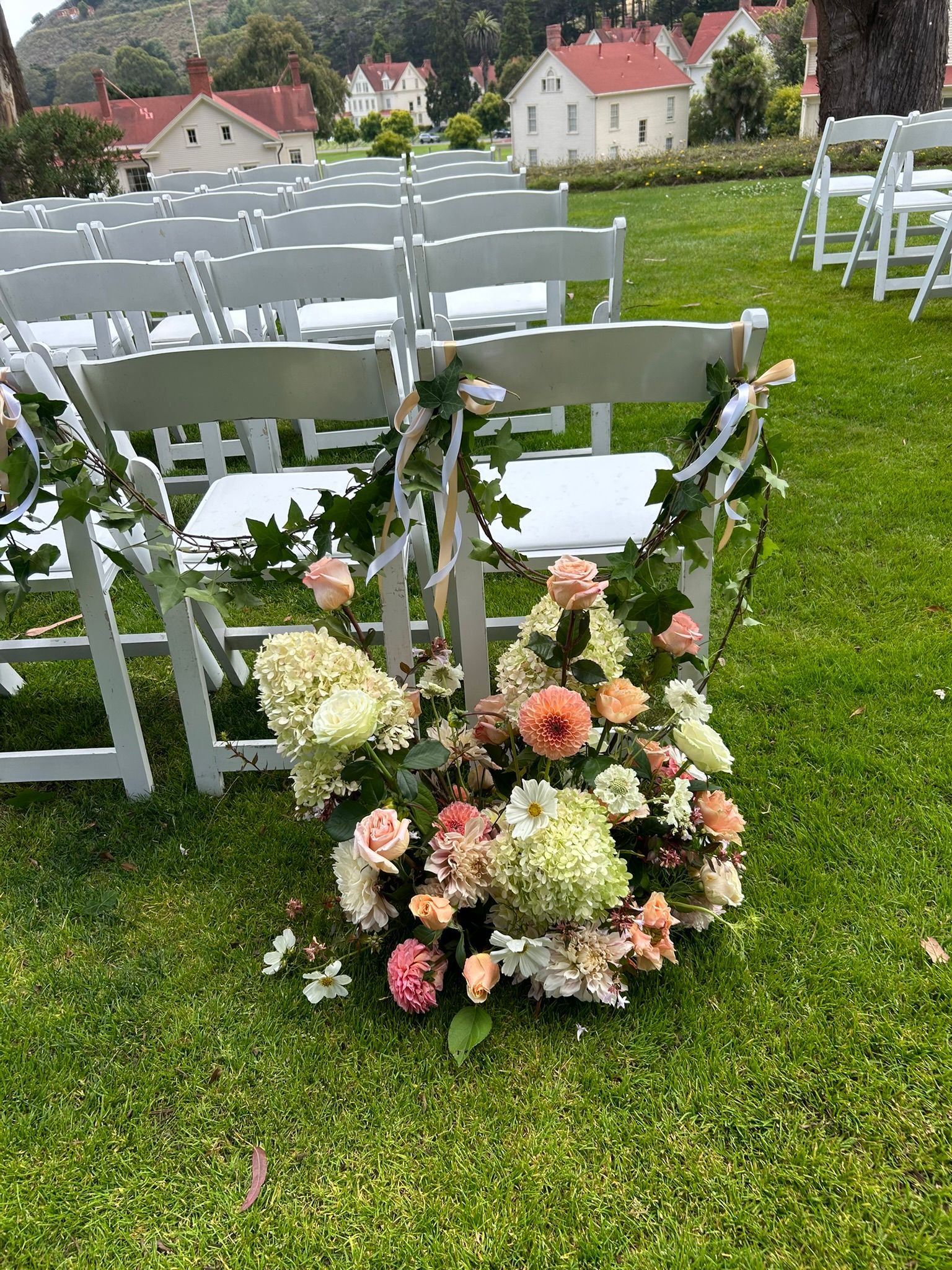 The end of the aisle designed in white and pink seasonal flowers.