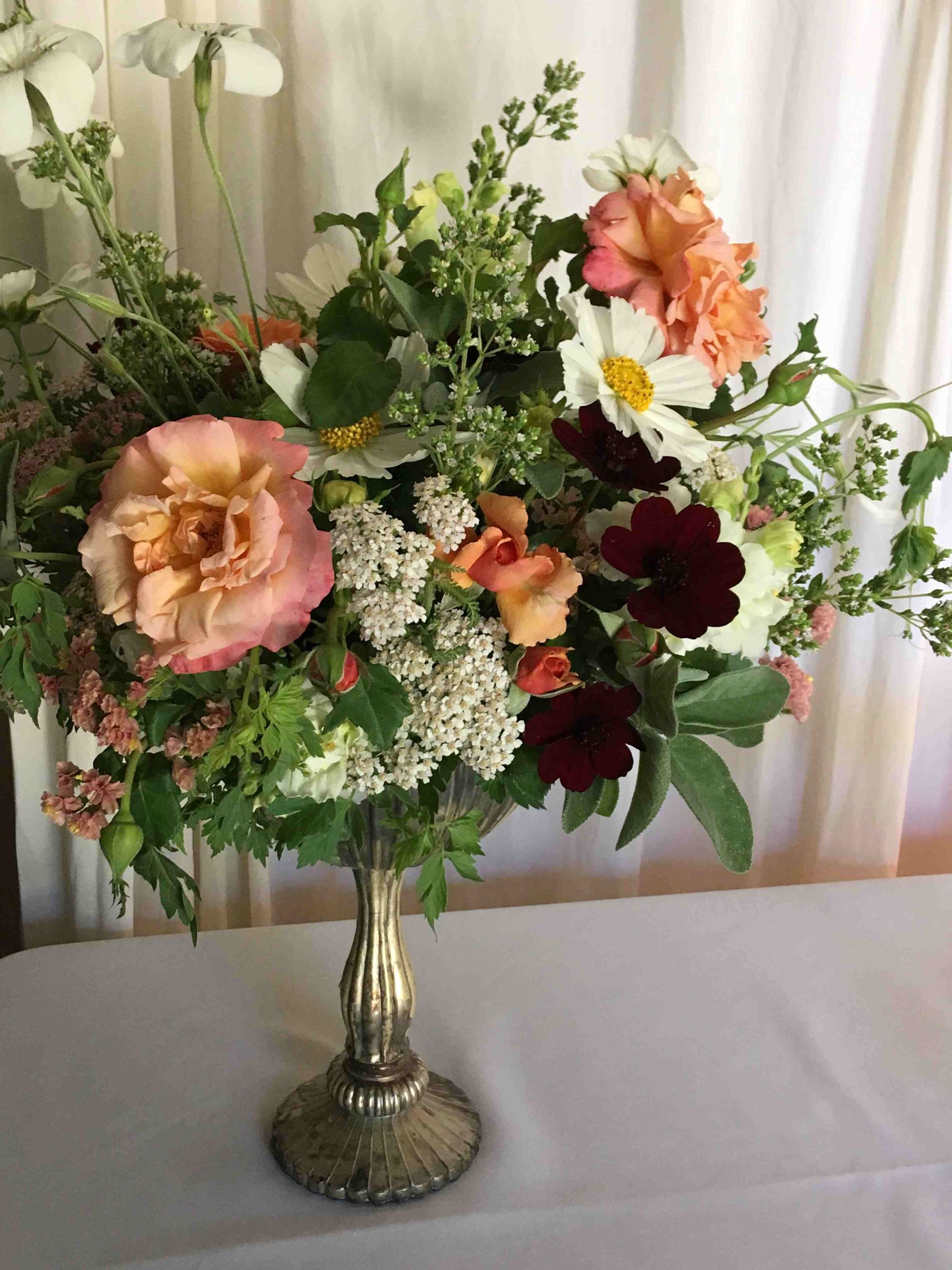 A vase filled with flowers is sitting on a table.