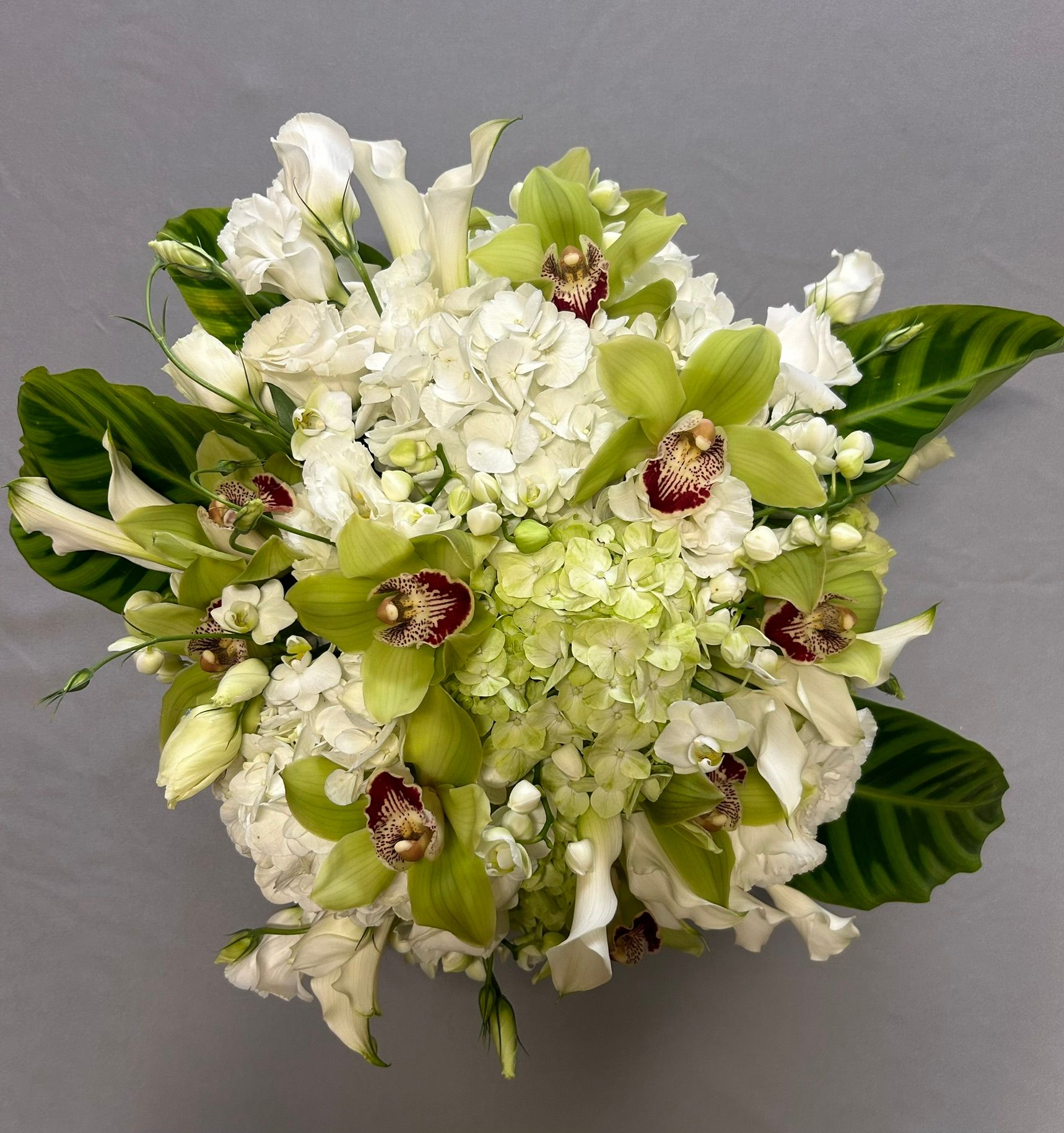 A bouquet of white and green flowers on a table