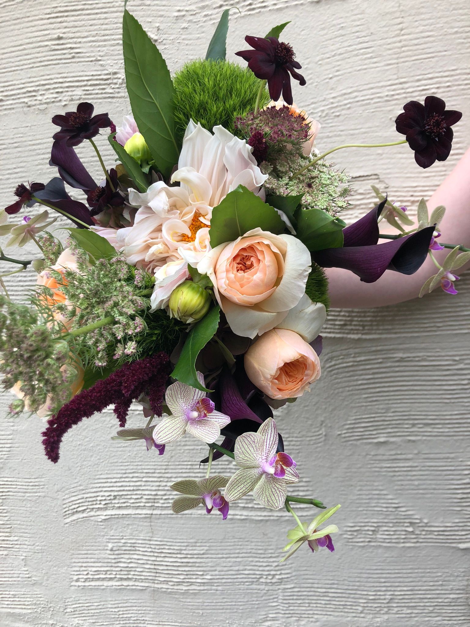 Unique bridal bouquet with eggplant calla lilies and chocolate cosmos