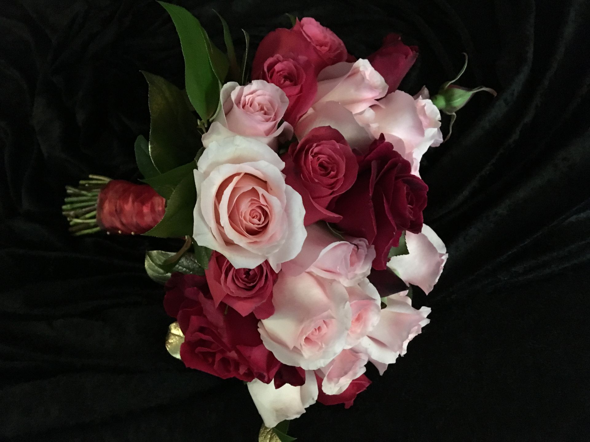 Red and Pink roses in a bridal bouquet with a touch of gold.