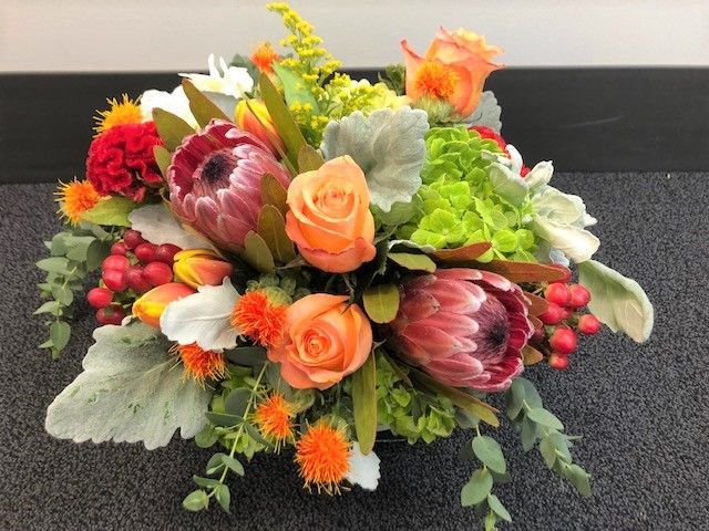 A bouquet of flowers is sitting on the floor