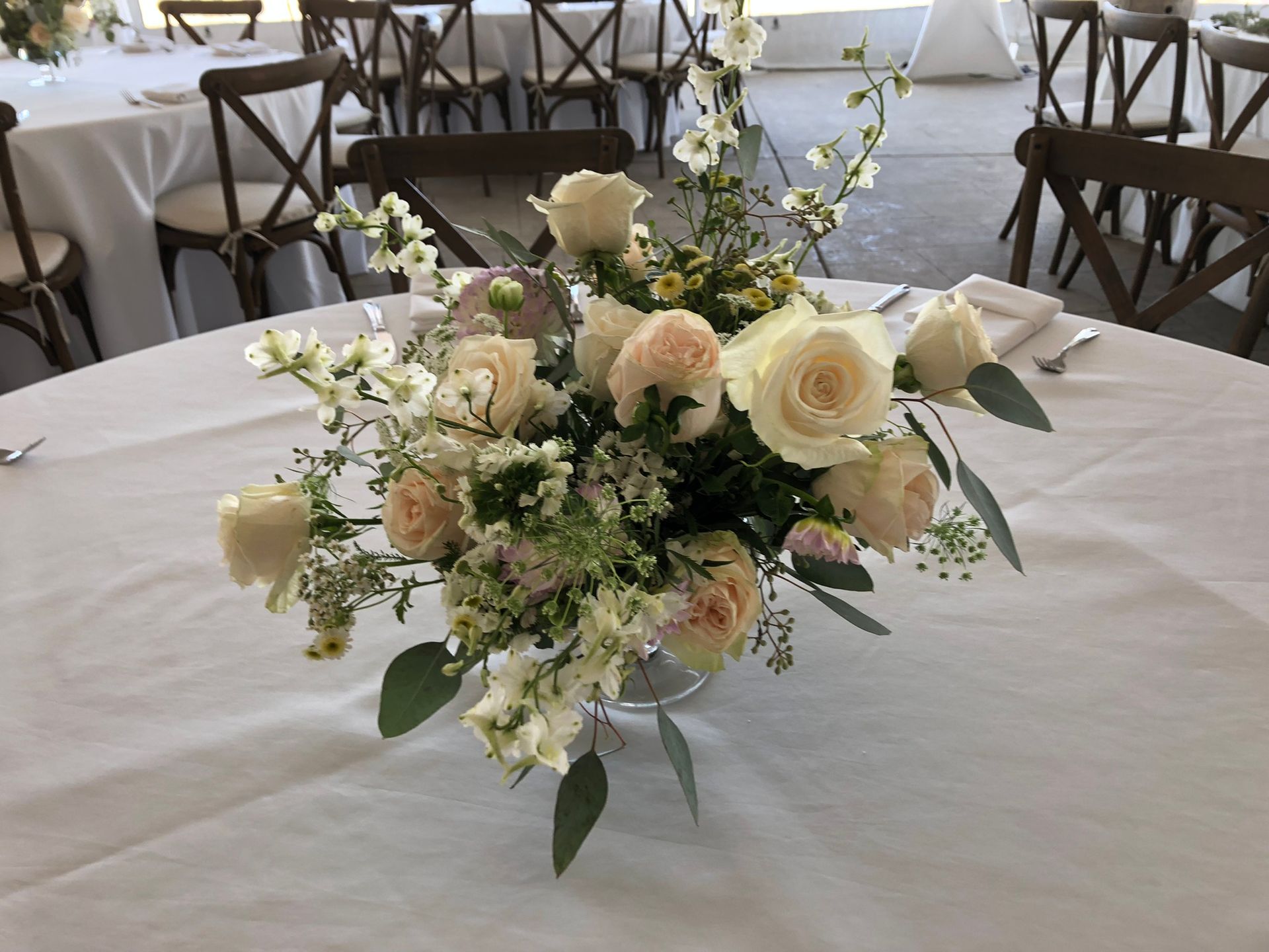 A table with a vase of flowers on it.
