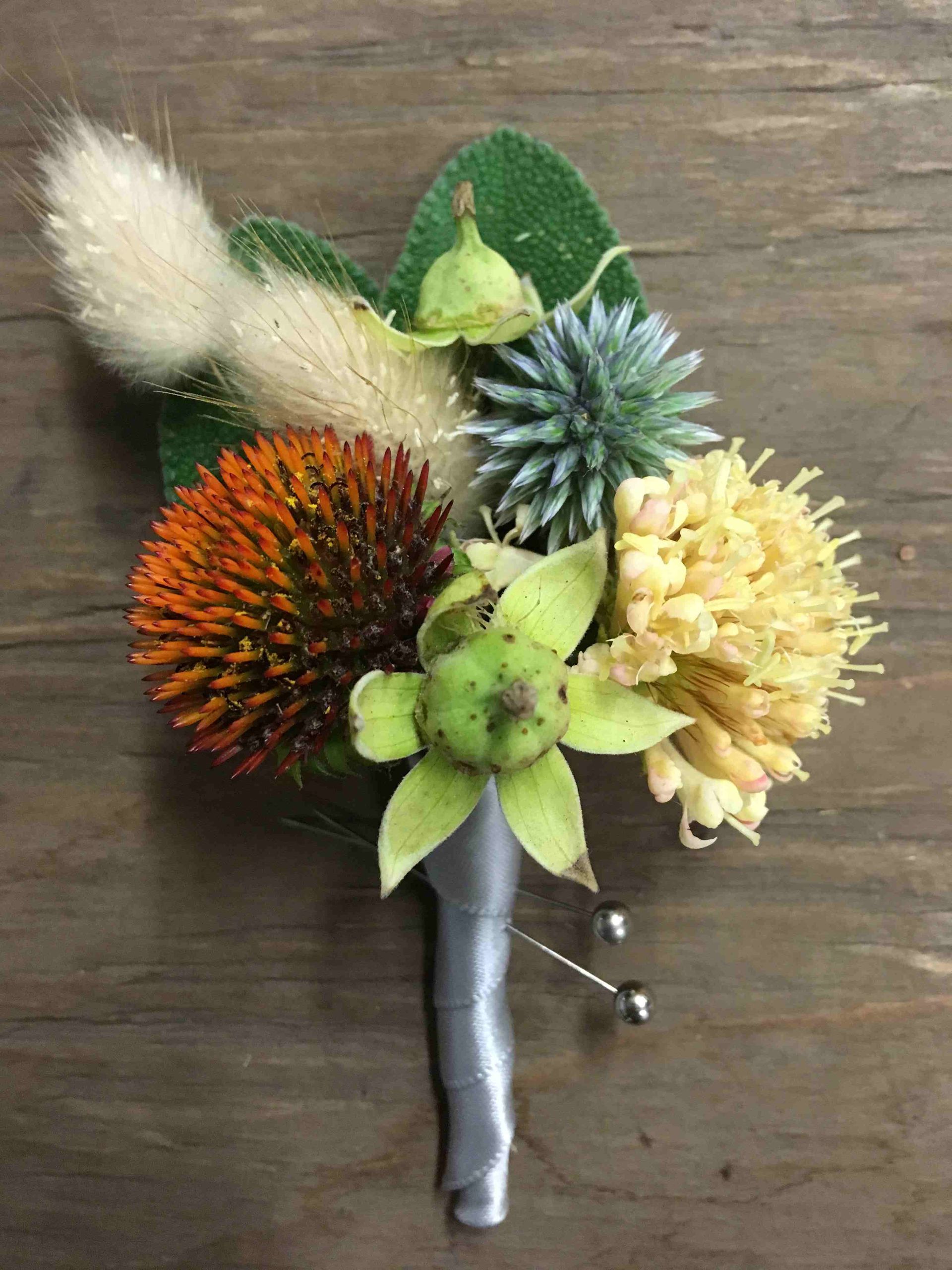 A close up of a flower arrangement on a wooden table.
