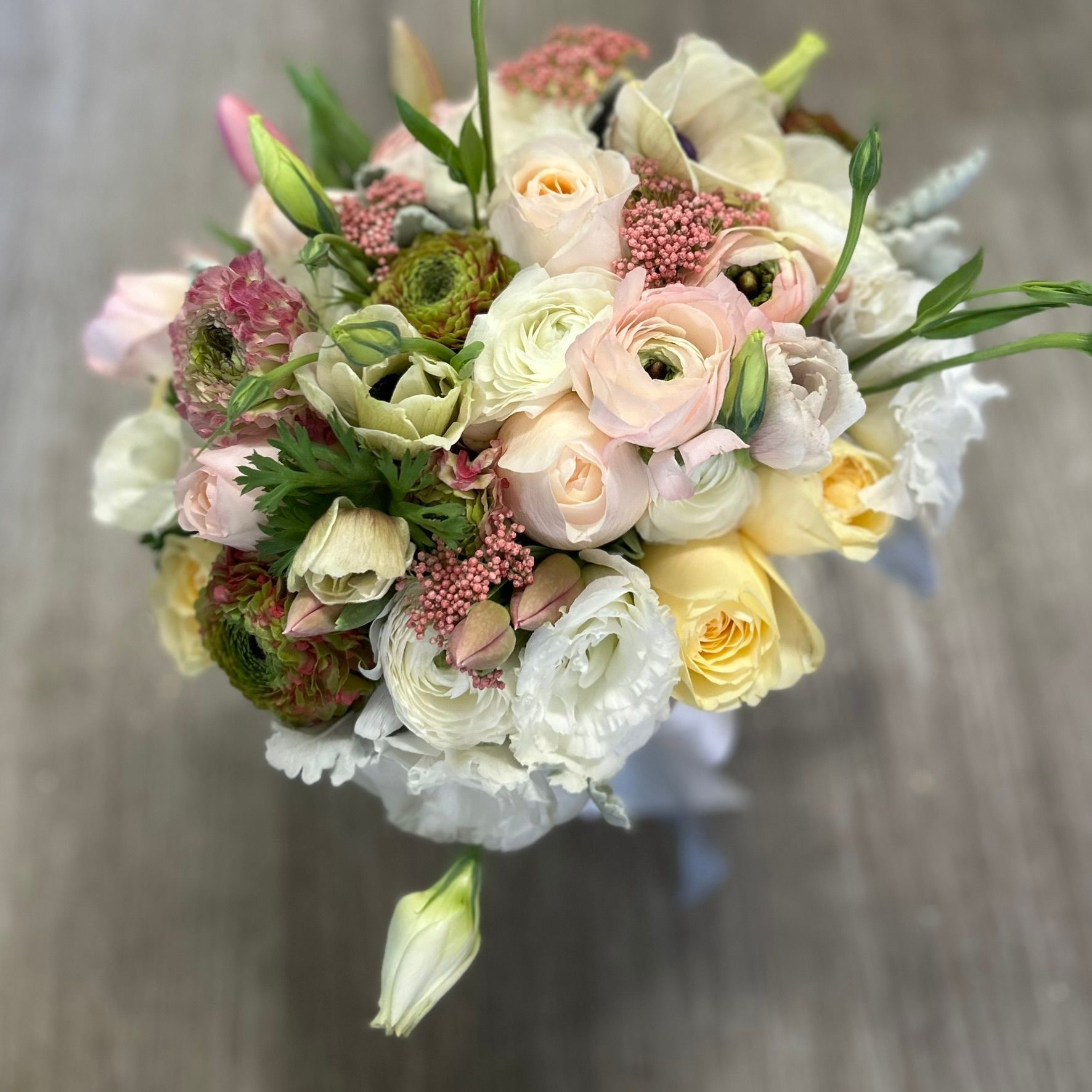 A pastel bridal bouquet with ranunculus and David Austin roses