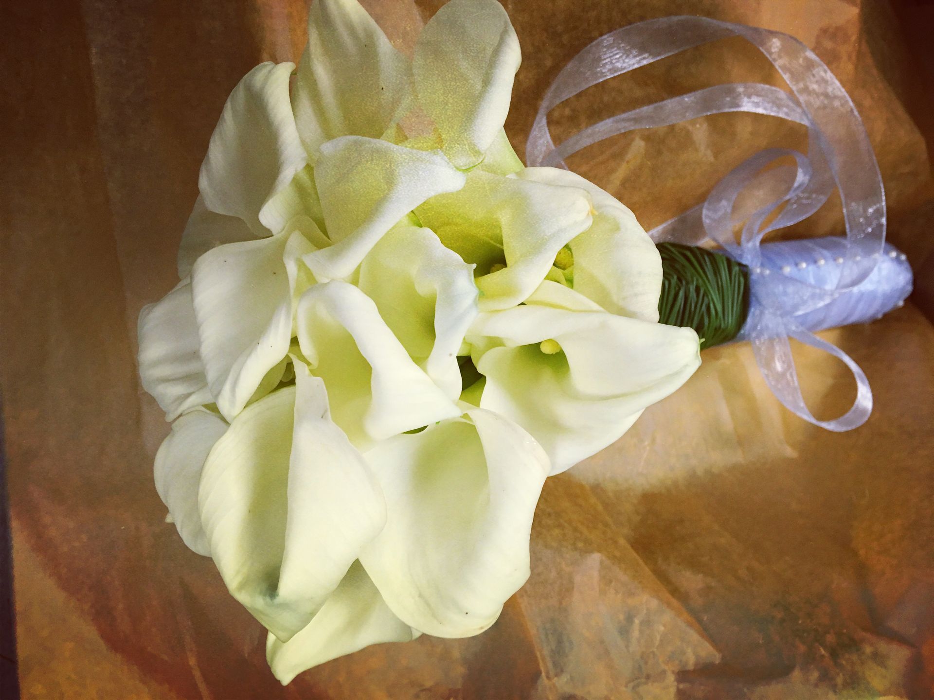 A modern bridal bouquet of all white calla lilies.