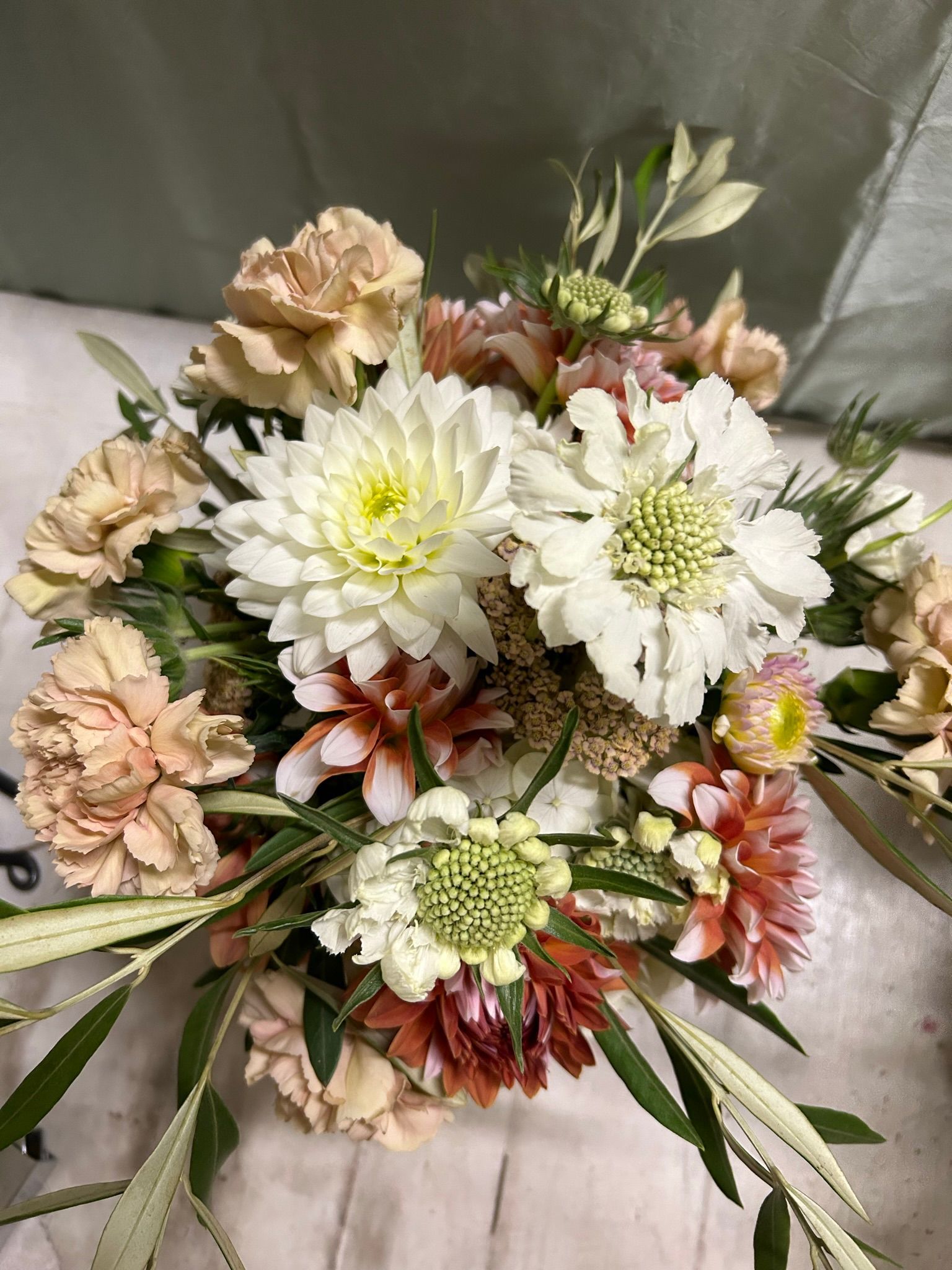 A close up of a bouquet of flowers on a table.