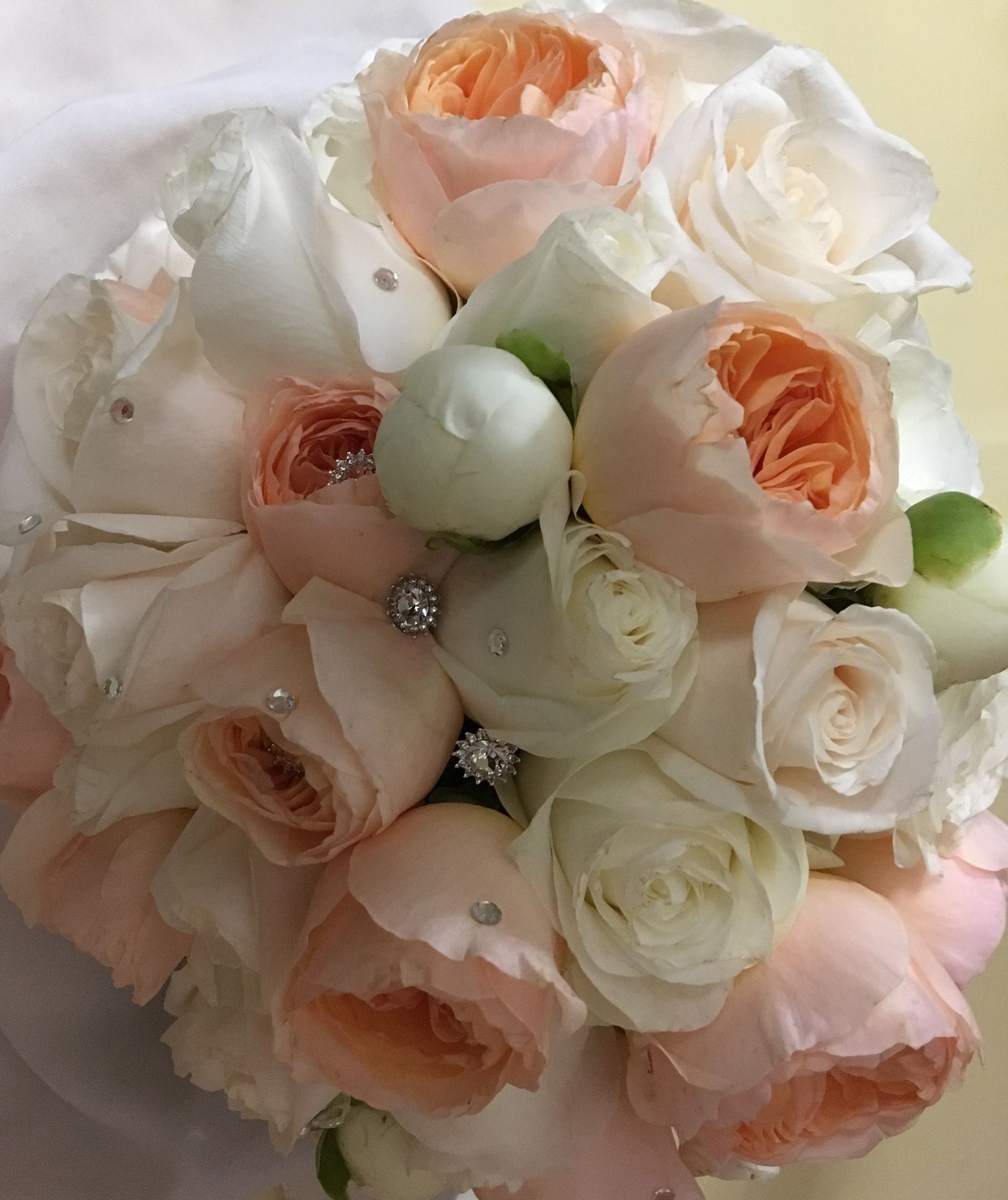 Bridal bouquet made with garden roses and peonies and decorated with rhinestones.